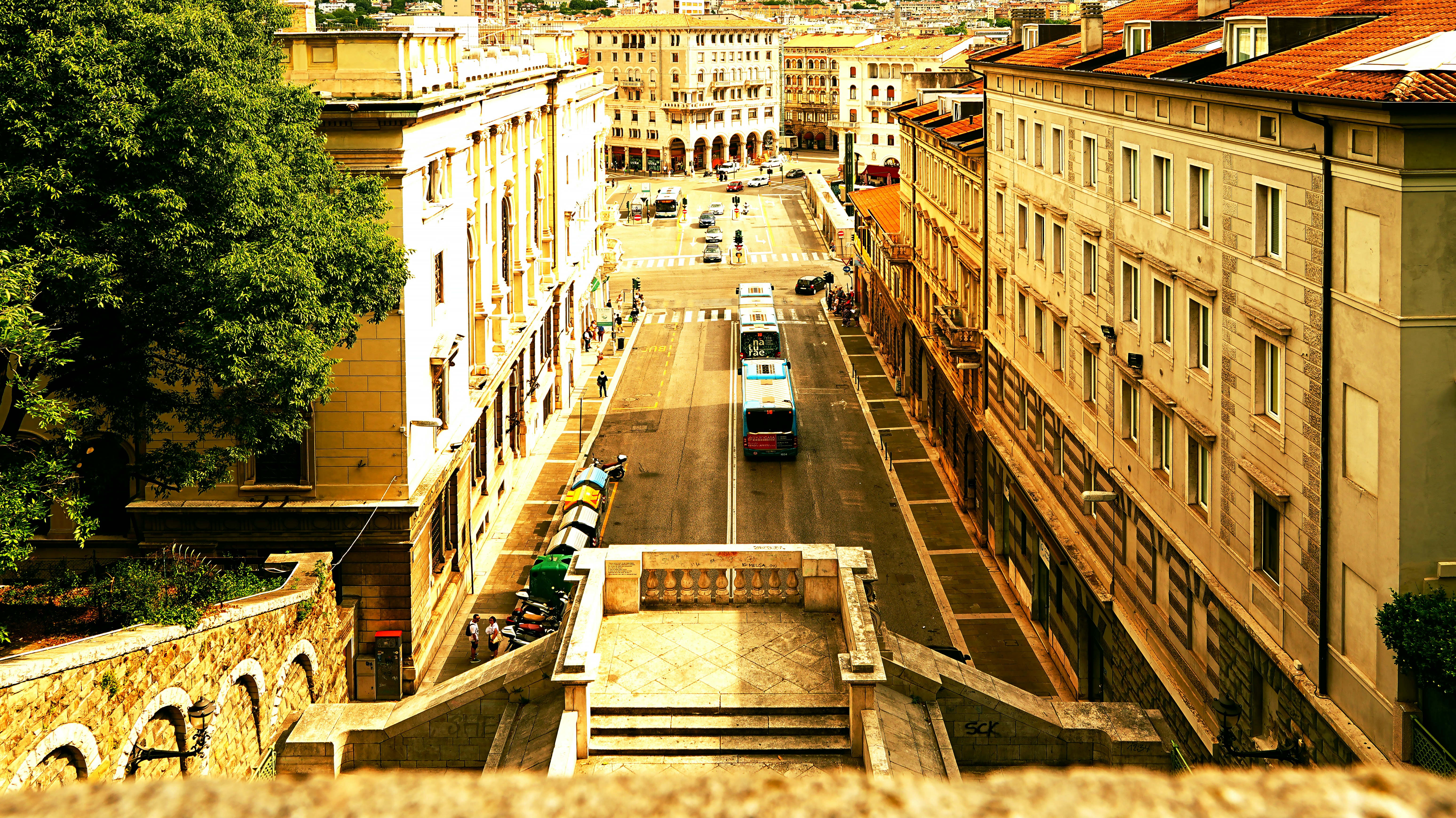 A bus drives down a street lined with buildings.