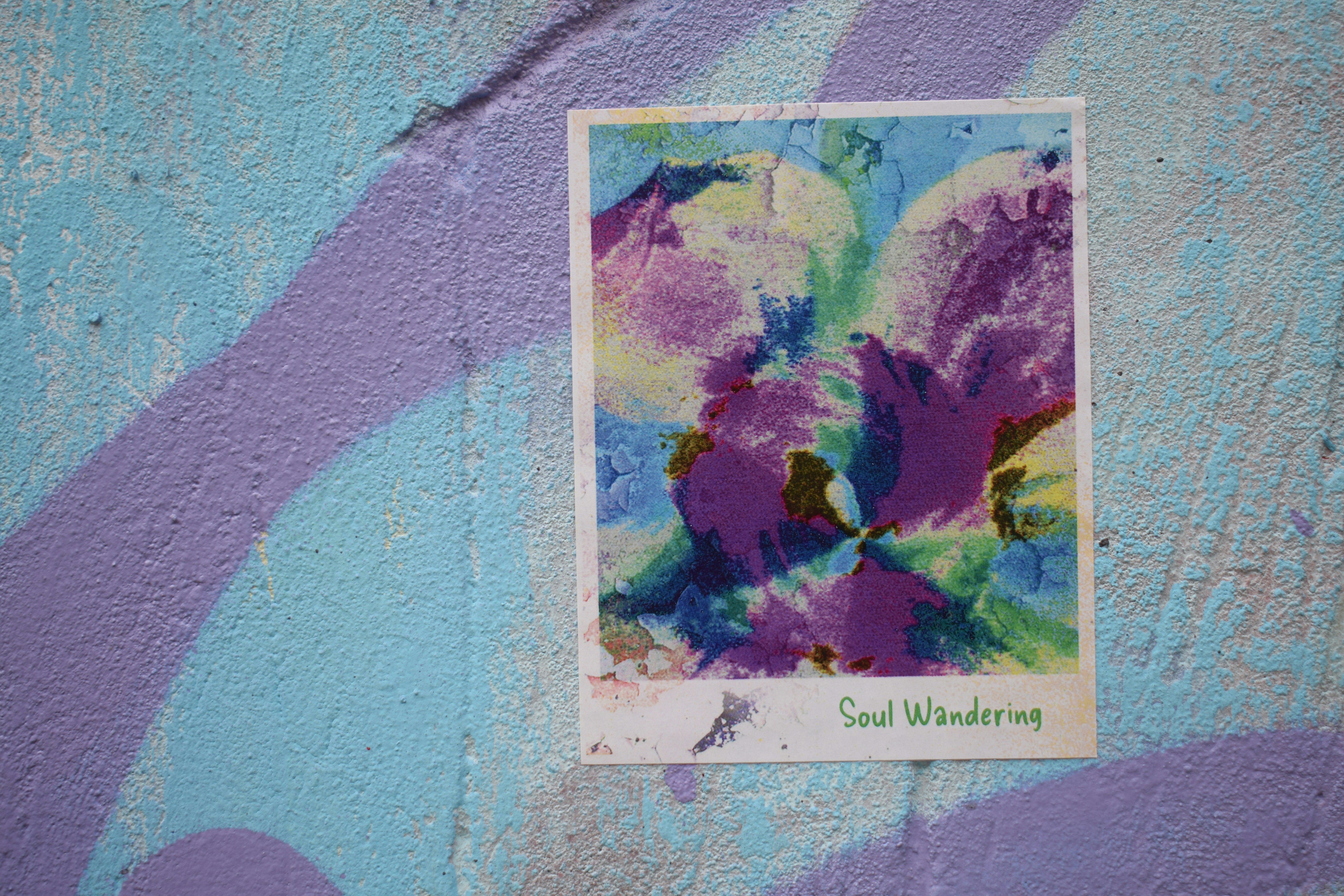 Abstract artwork with purple and blue paint on wall