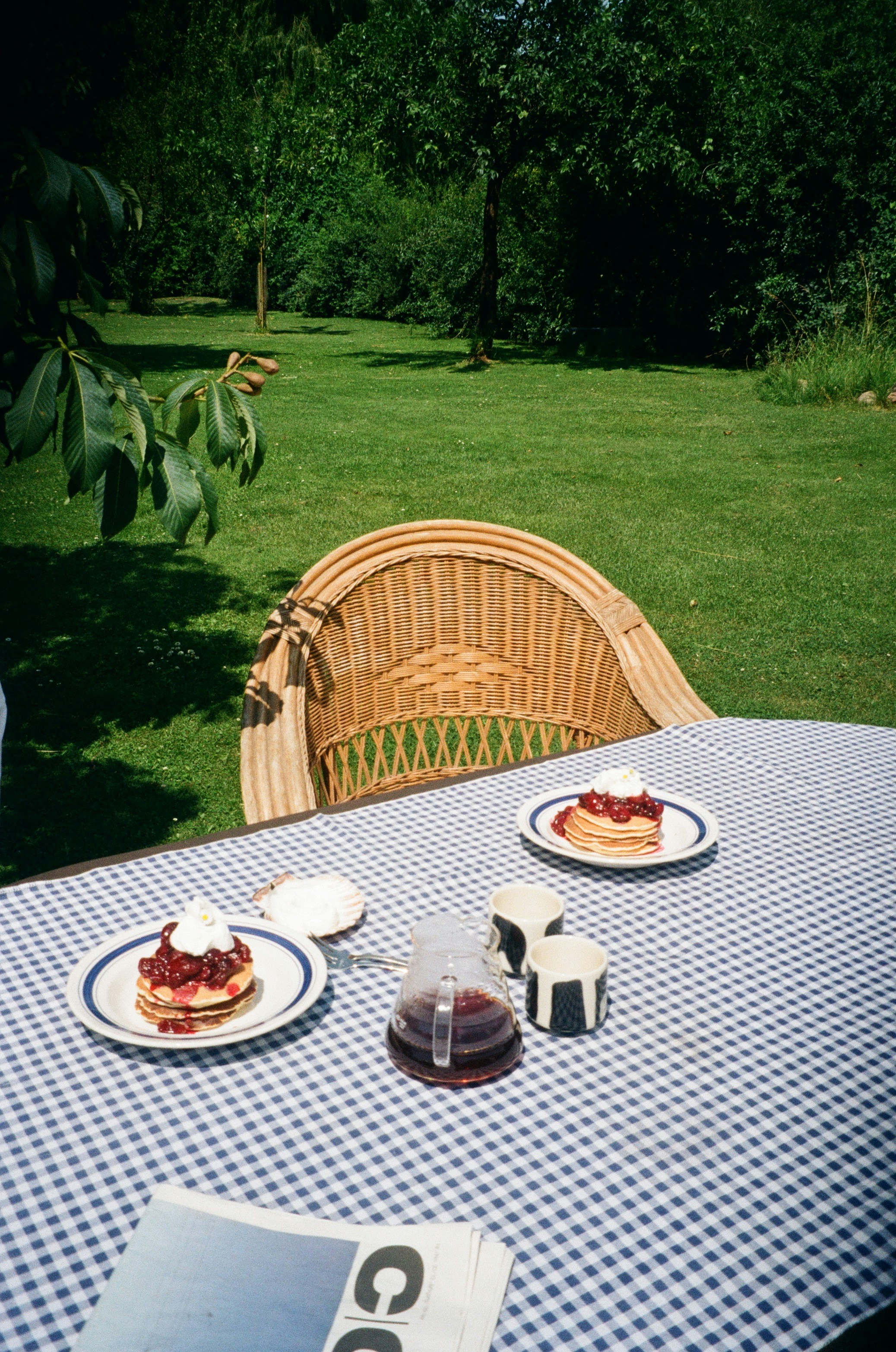 Pancakes with fruit and cream served outdoors