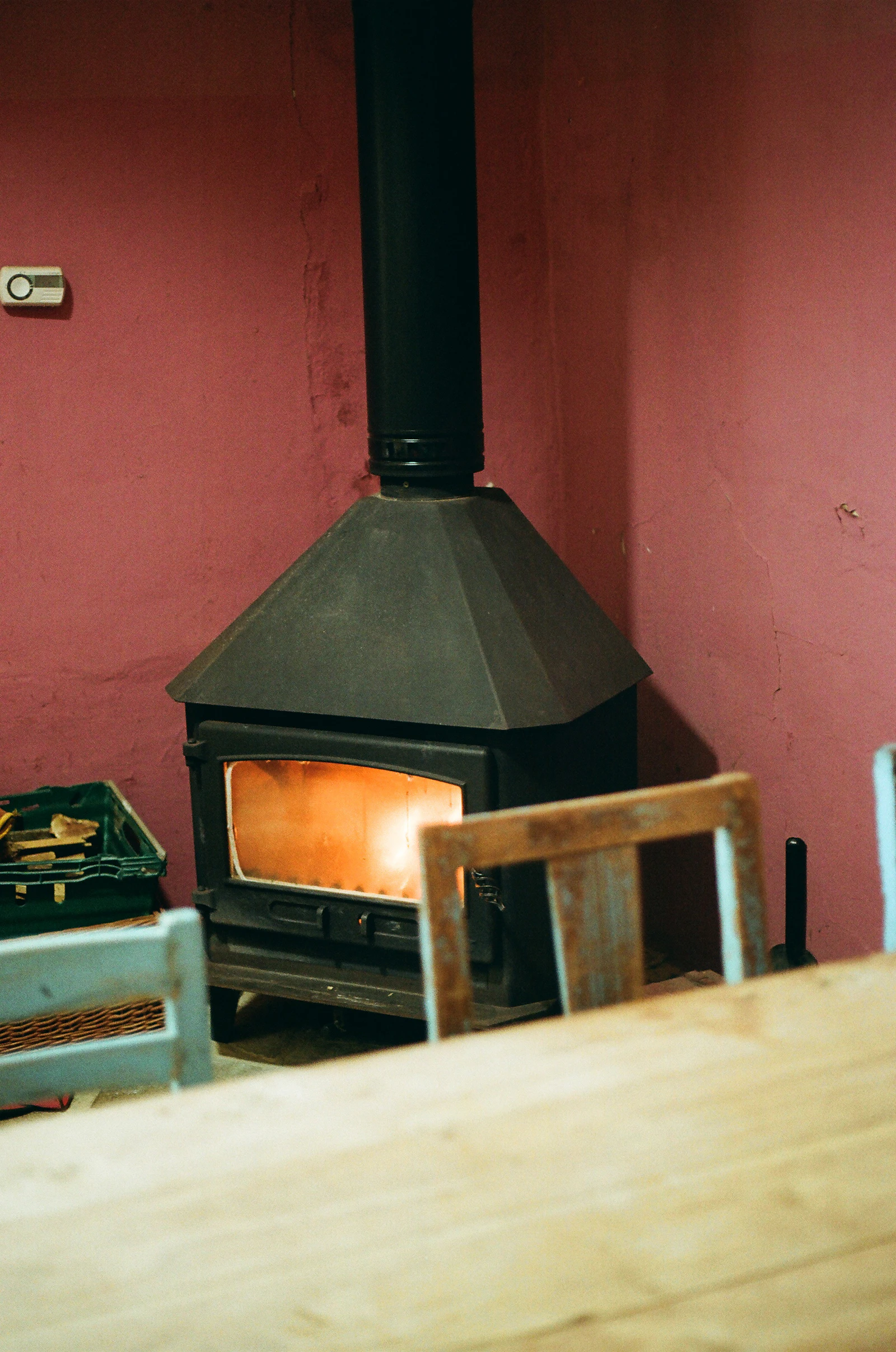 Wood-burning stove glowing in a warm rustic room