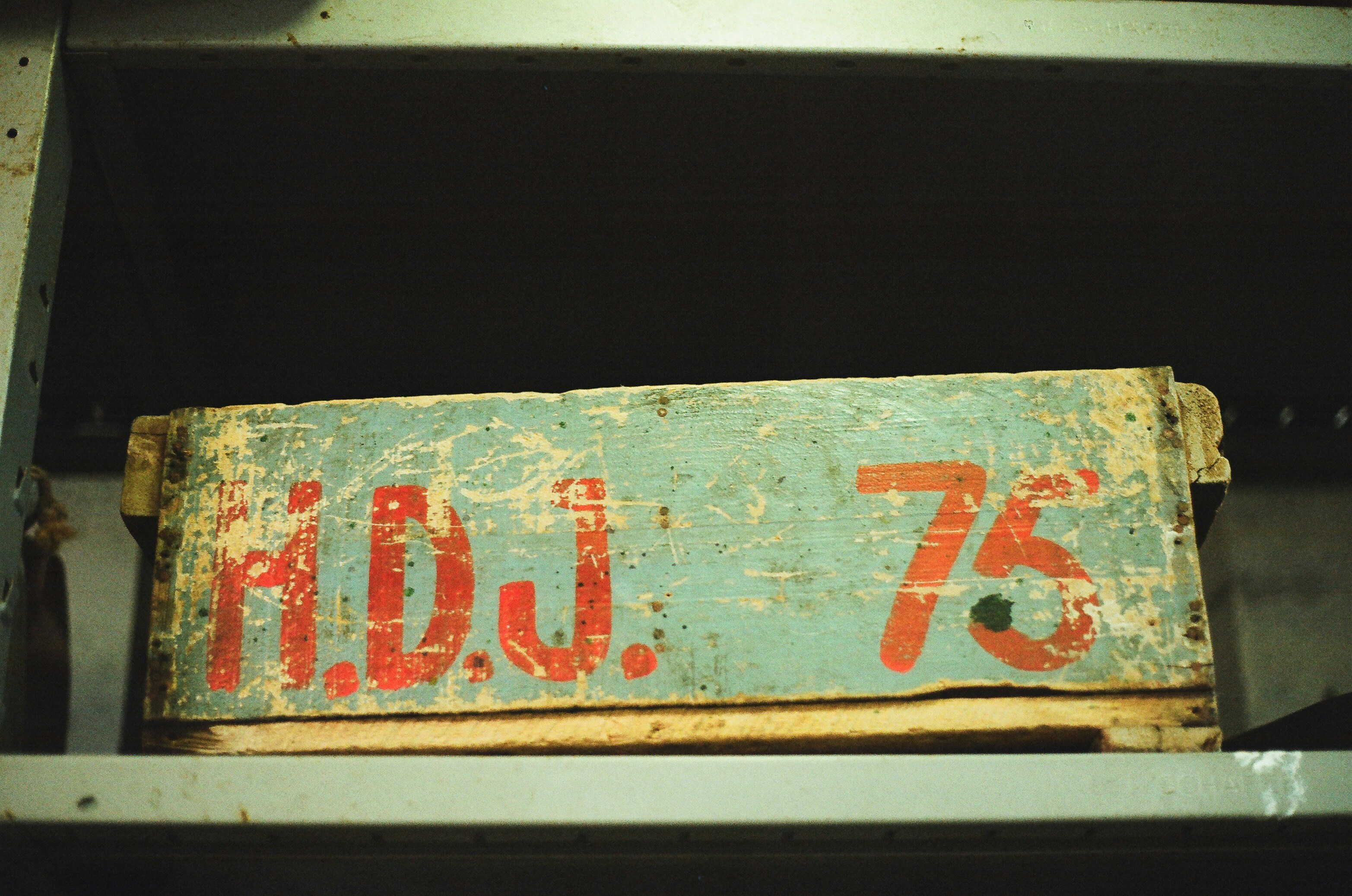 Old wooden crate with red lettering "h.d.j. 75"