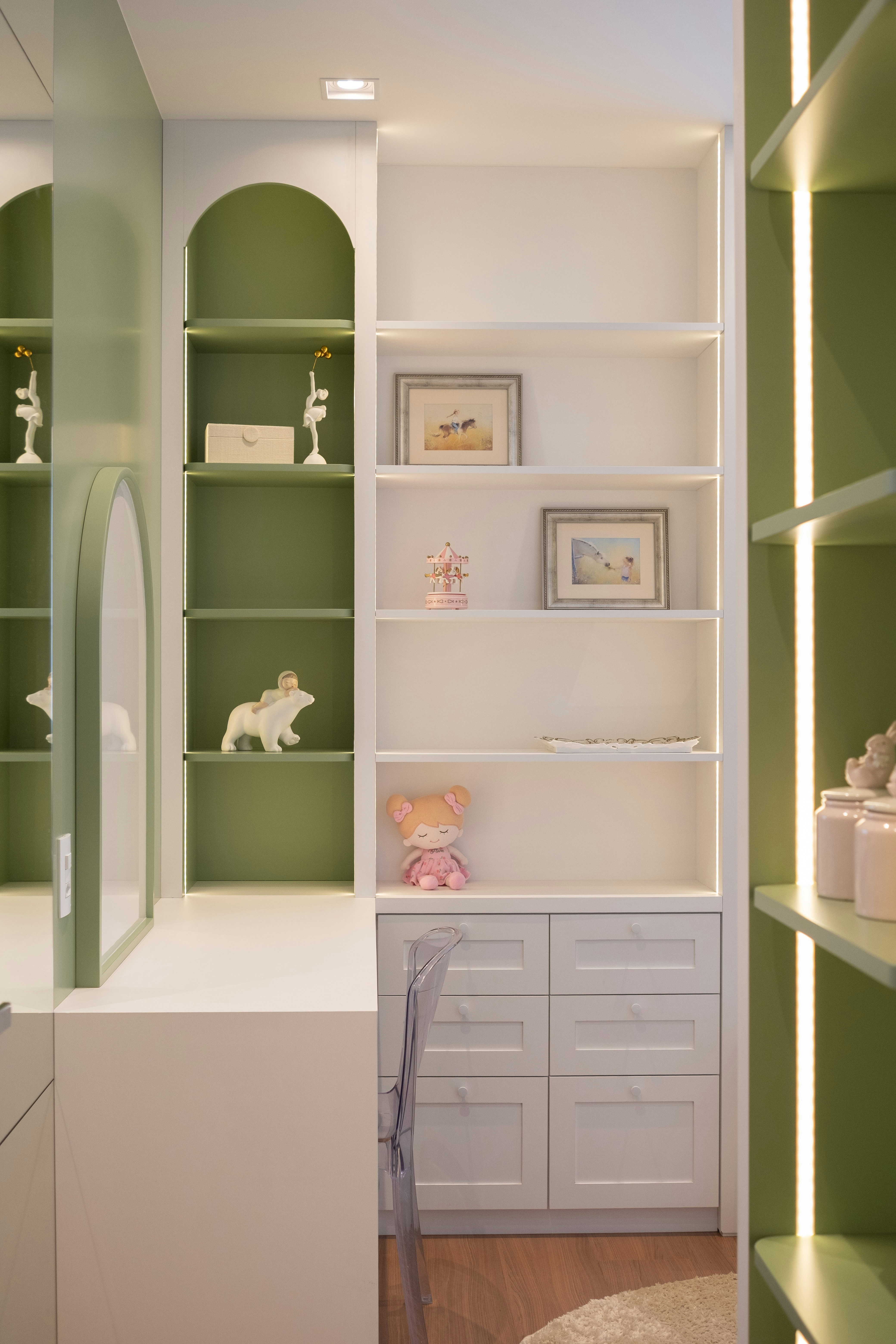 Modern shelving unit with decorative items and drawers.