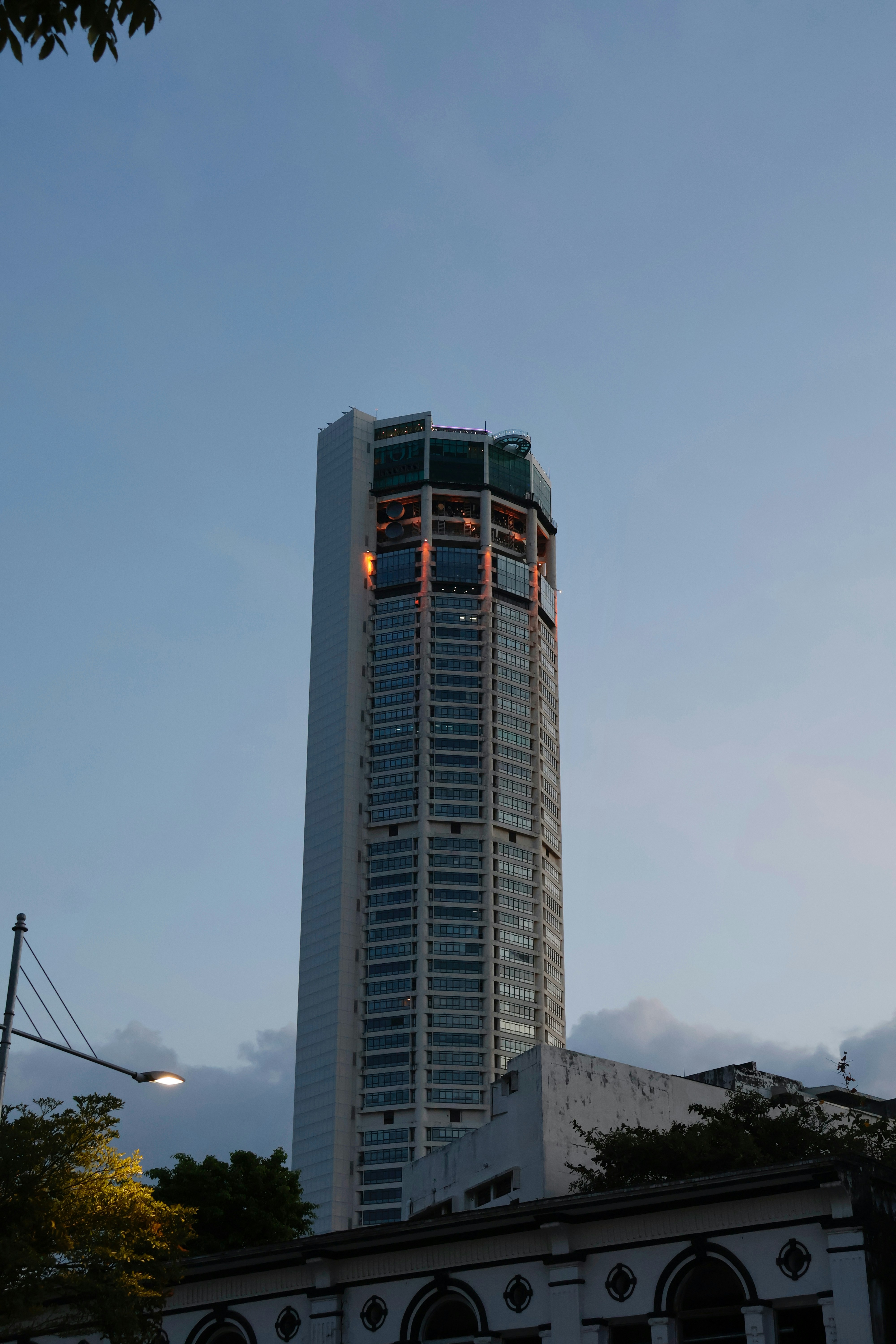 Tall skyscraper with lights against a clear sky