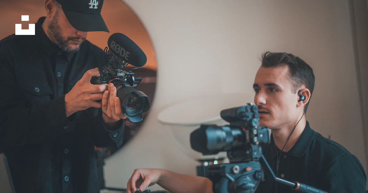 Video Camera Men Two men operating professional video cameras indoors. photo – Free ...