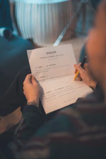Person reading a script with a pen