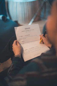 Person reading a script with a pen