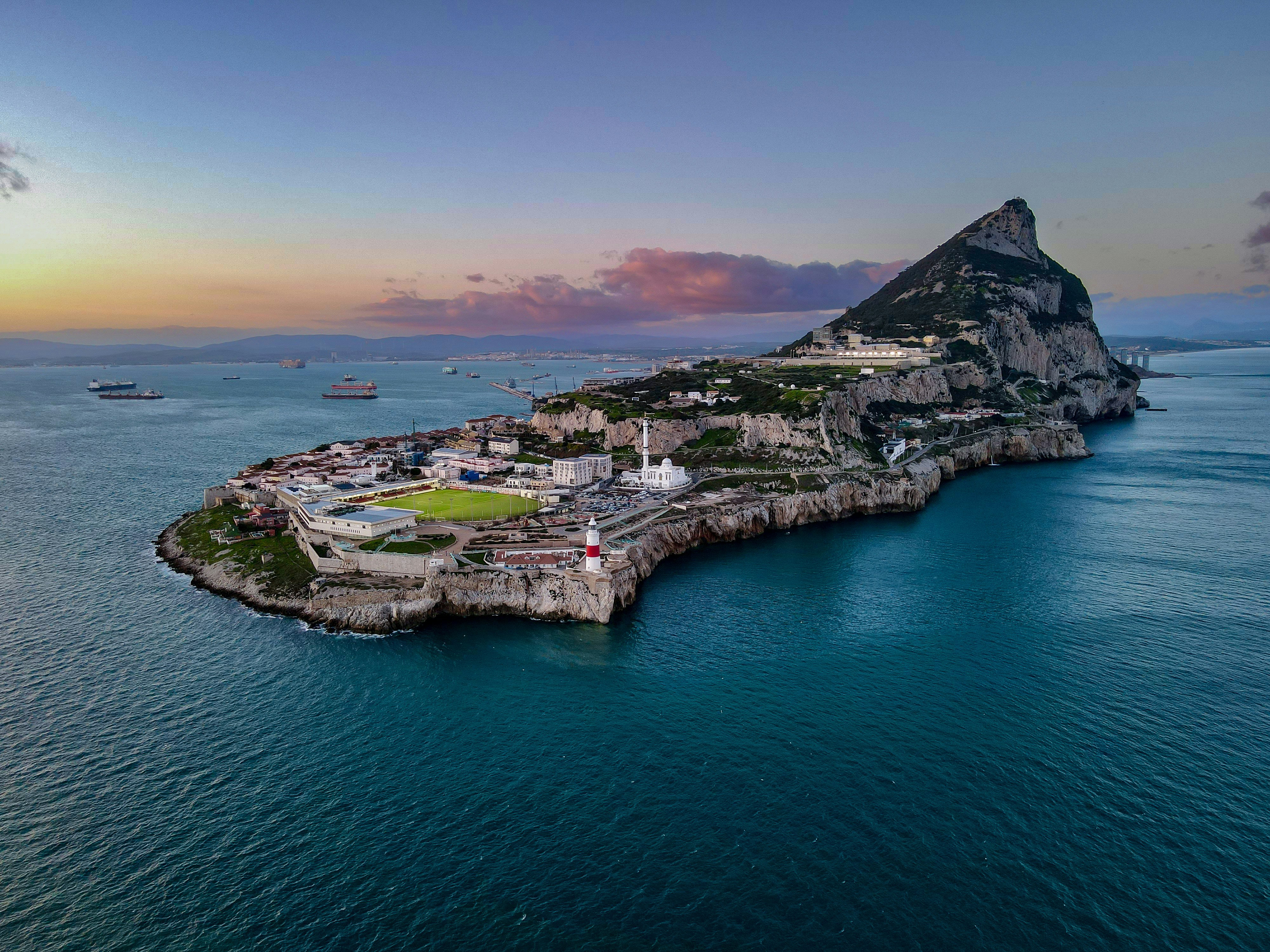 Gibraltar peninsula with the rock and lighthouse at sunset