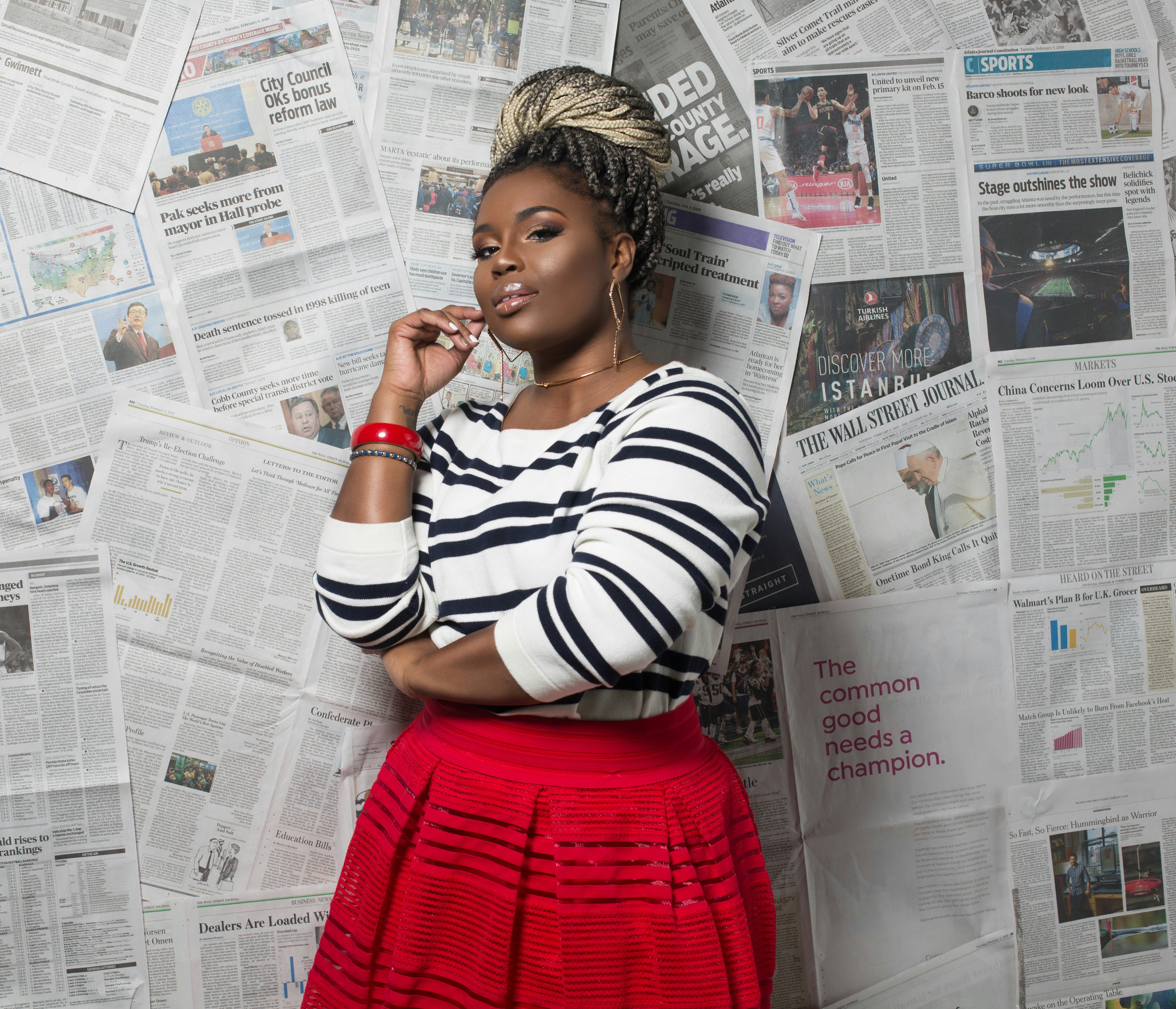 A woman in a striped shirt and red skirt