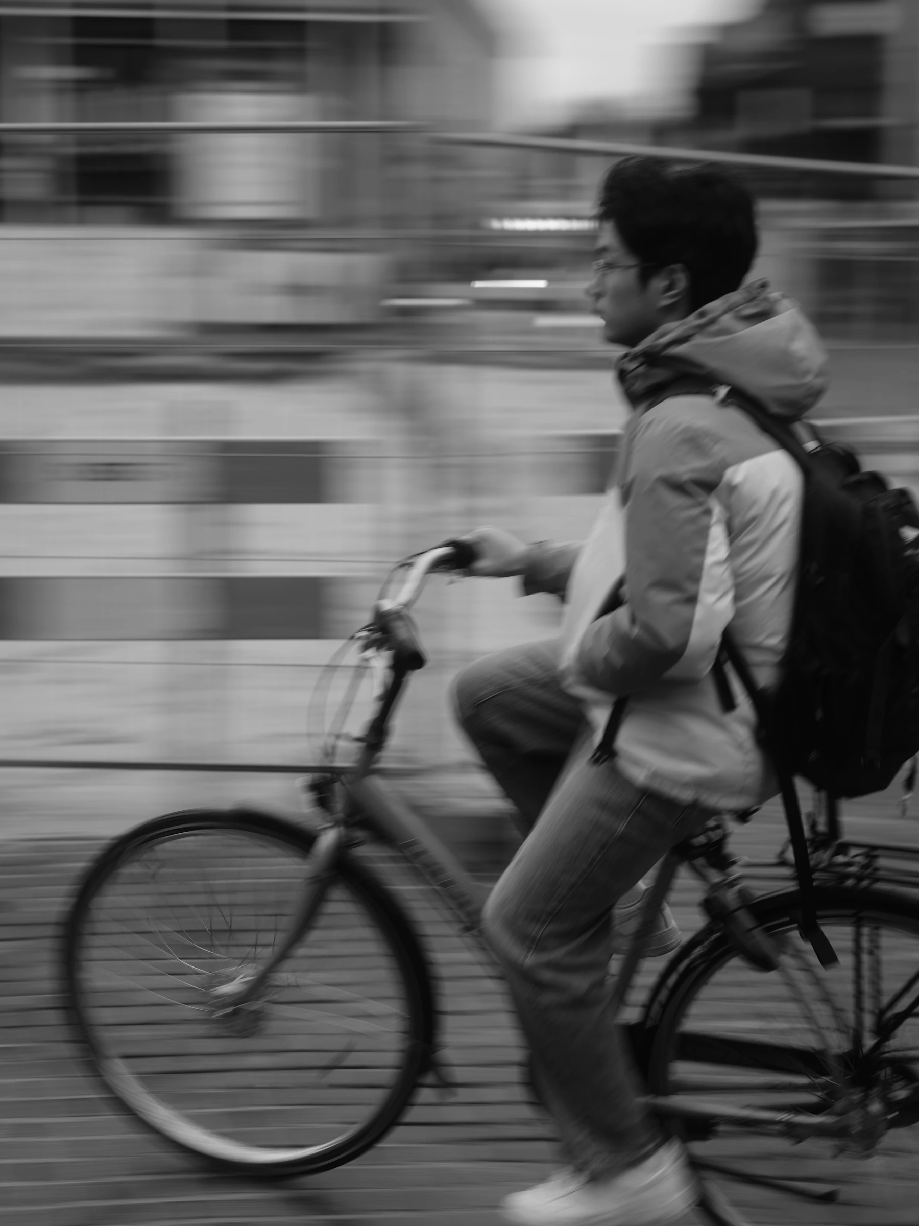 A young adult moving confidently through the city by bicycle