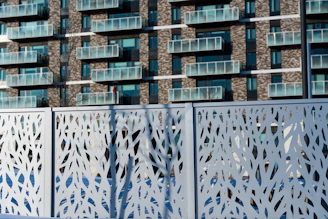 Modern apartment building behind decorative screen