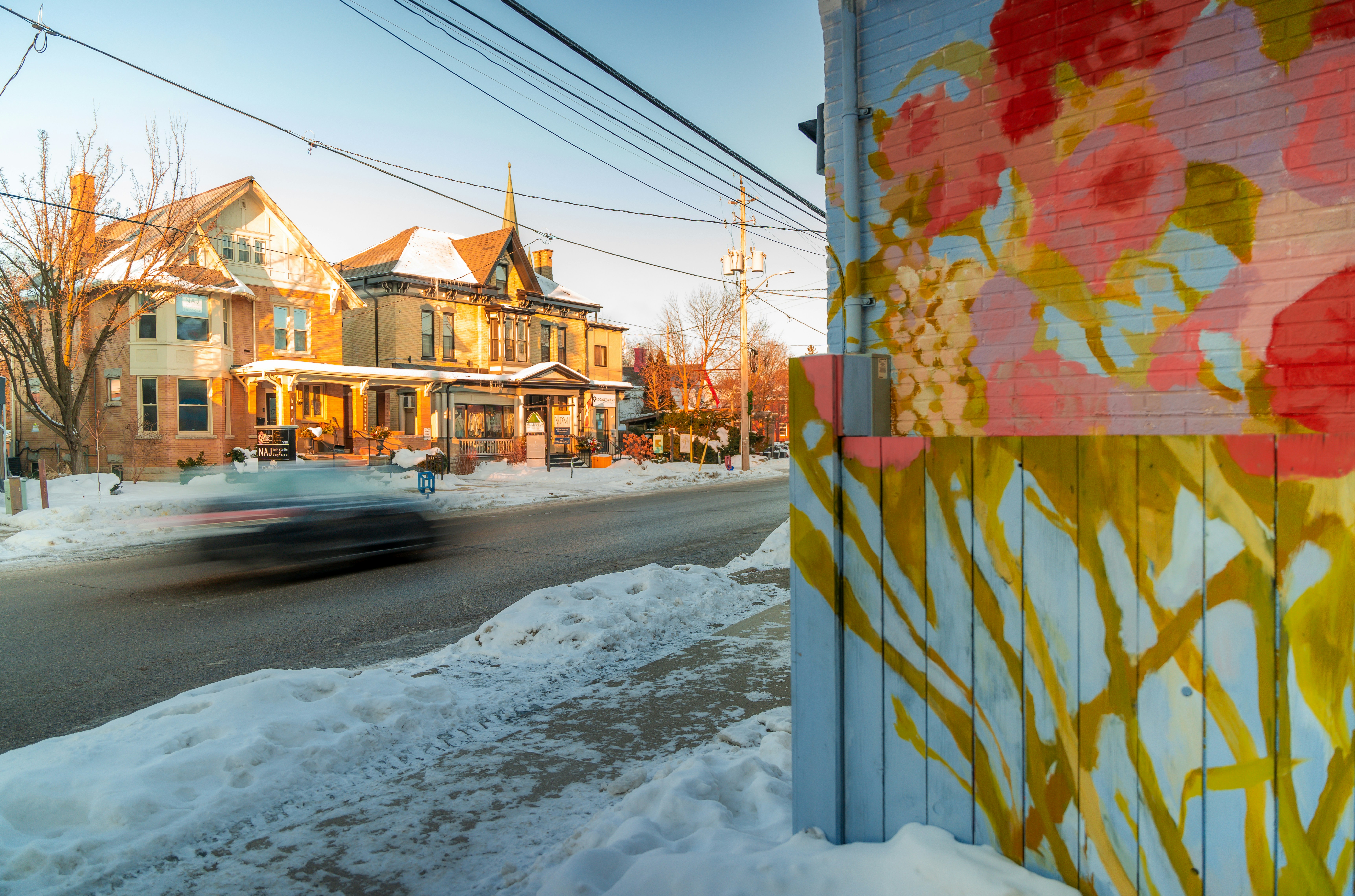 Street art and houses on a snowy winter day.