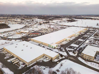 Aerial view of industrial warehouses covered in snow