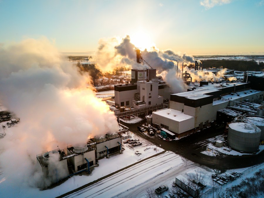 Industrial smokestacks against cold sky