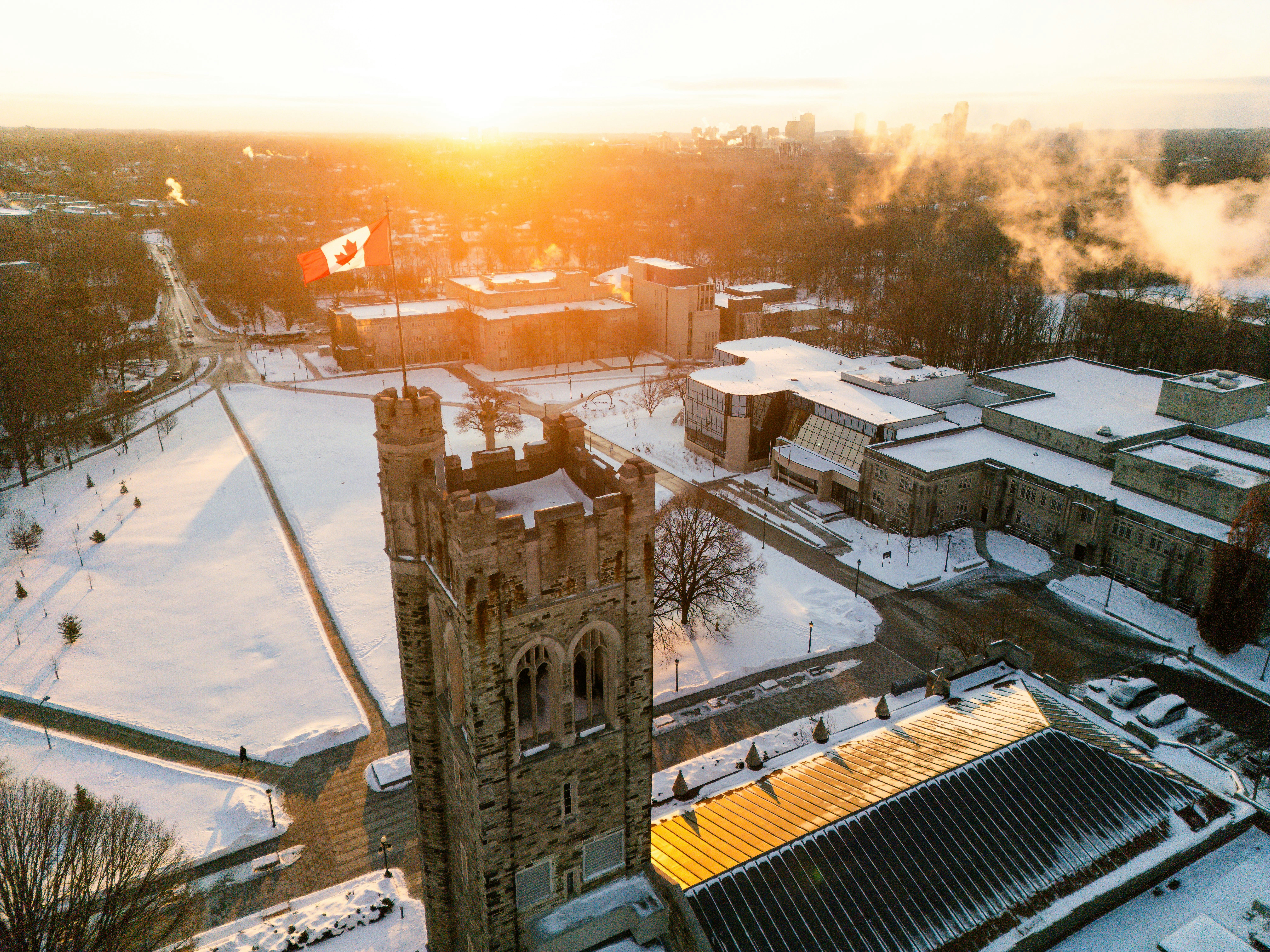 Snow-covered Canadian university campus with historic stone buildings