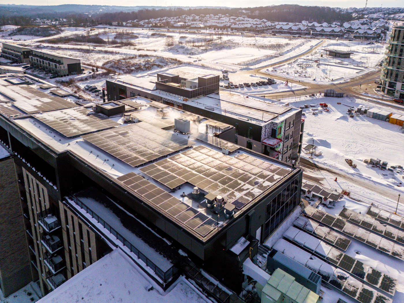 Rooftop solar panels on a modern building in winter