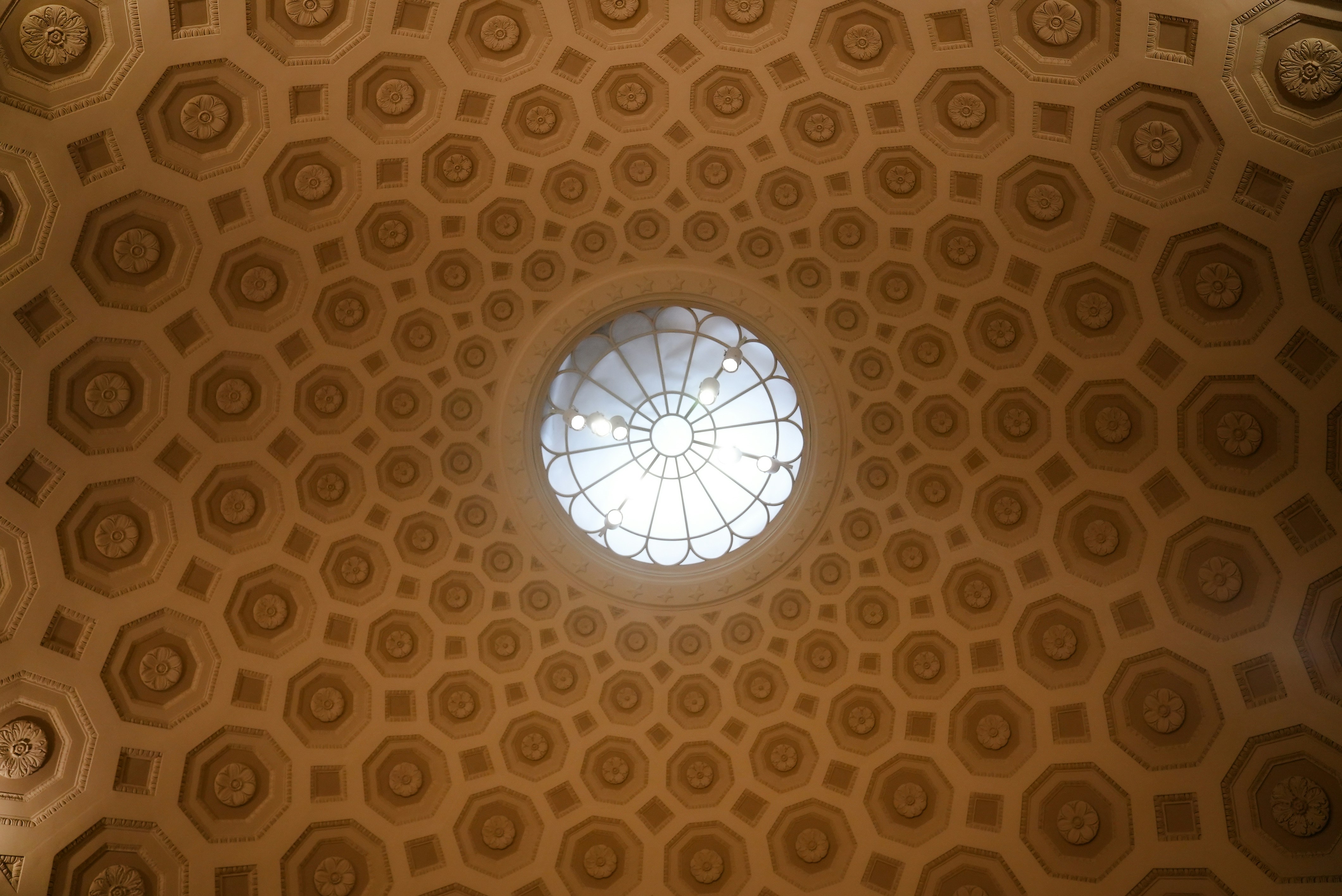 Intricate geometric patterned ceiling with central skylight.