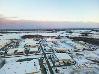 Aerial view of industrial buildings in a snowy landscape.