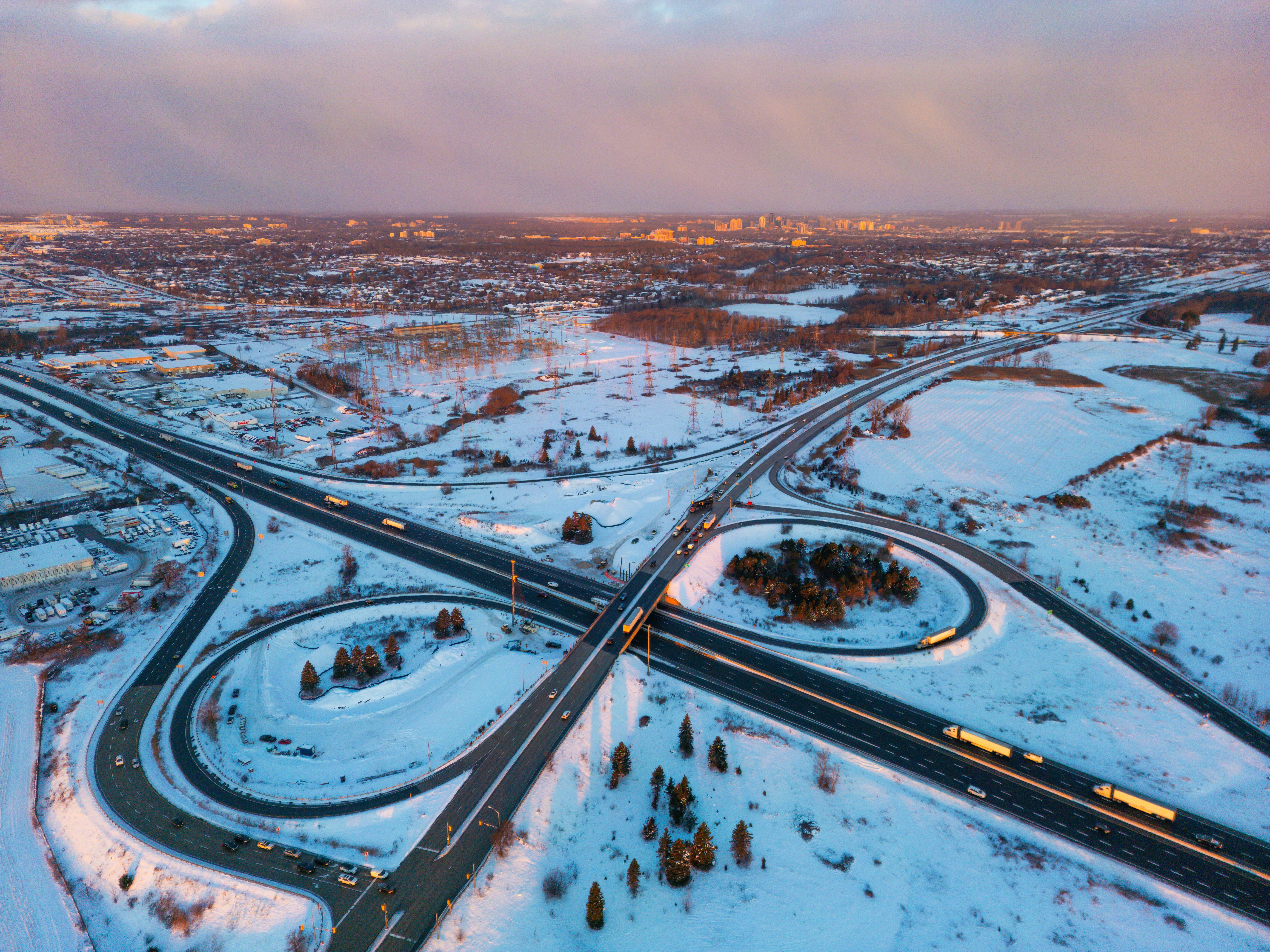Snowy highway interchange with traffic at dusk