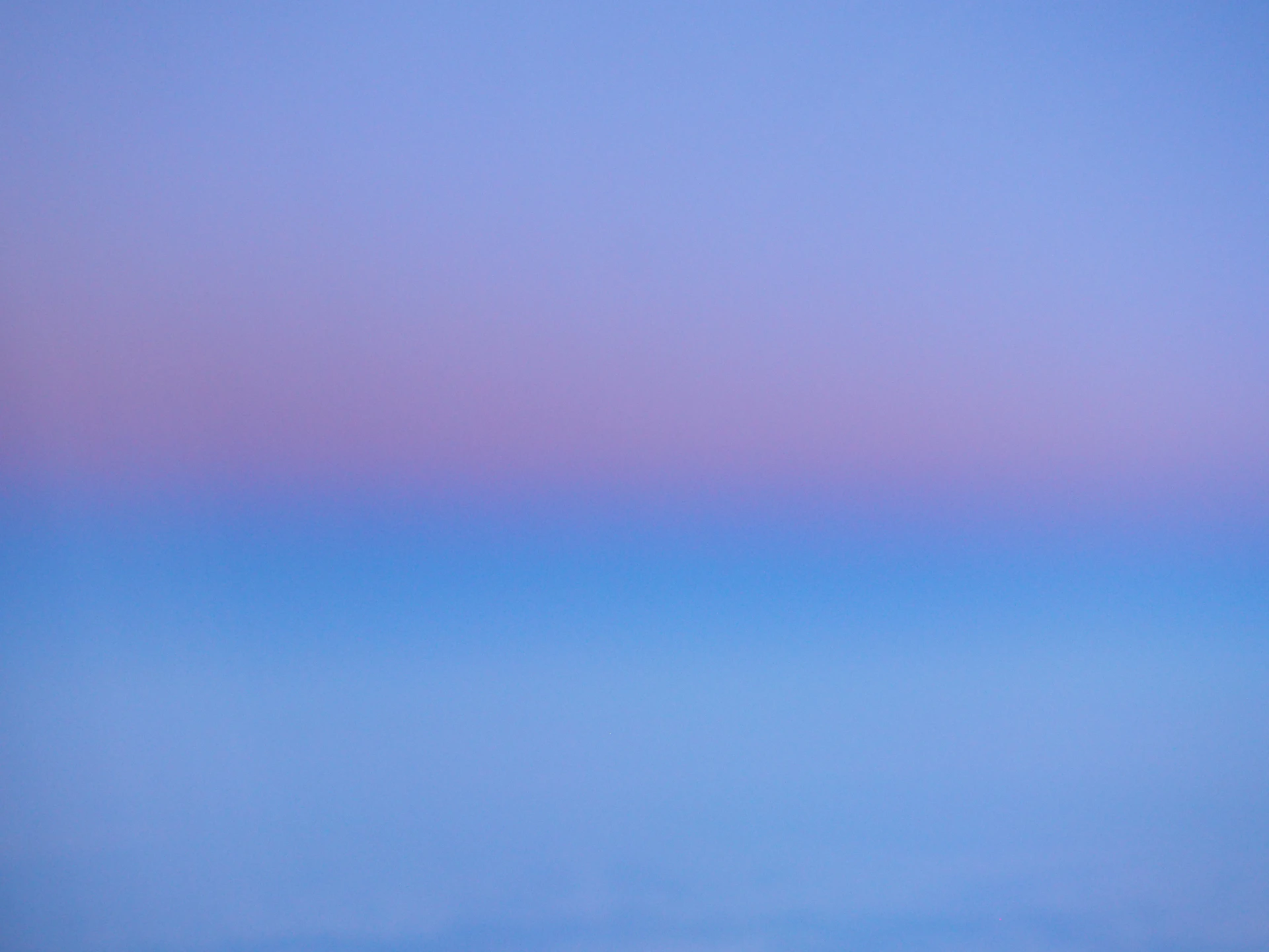 Soft gradient of blue and pink sky at dusk