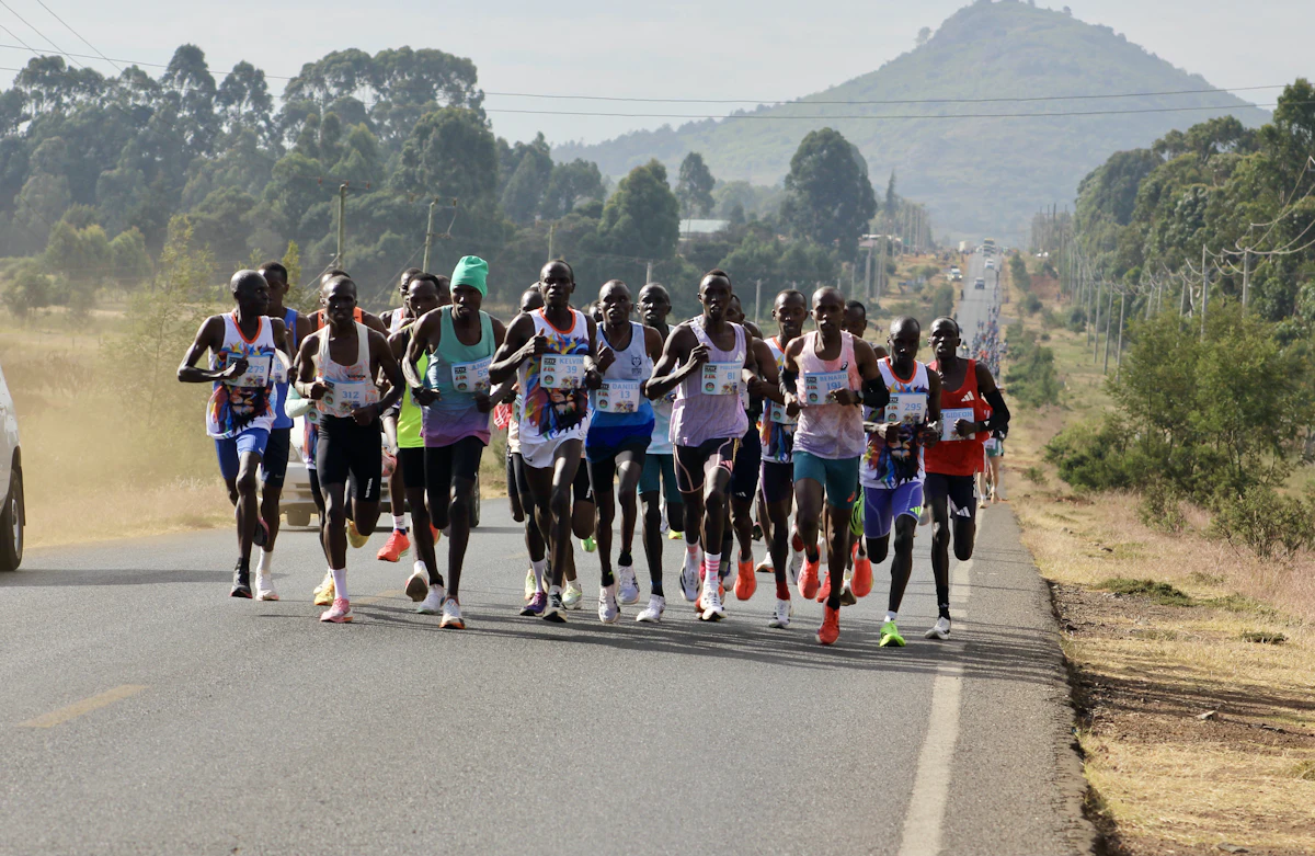 Runners on a country road with a mountain behind