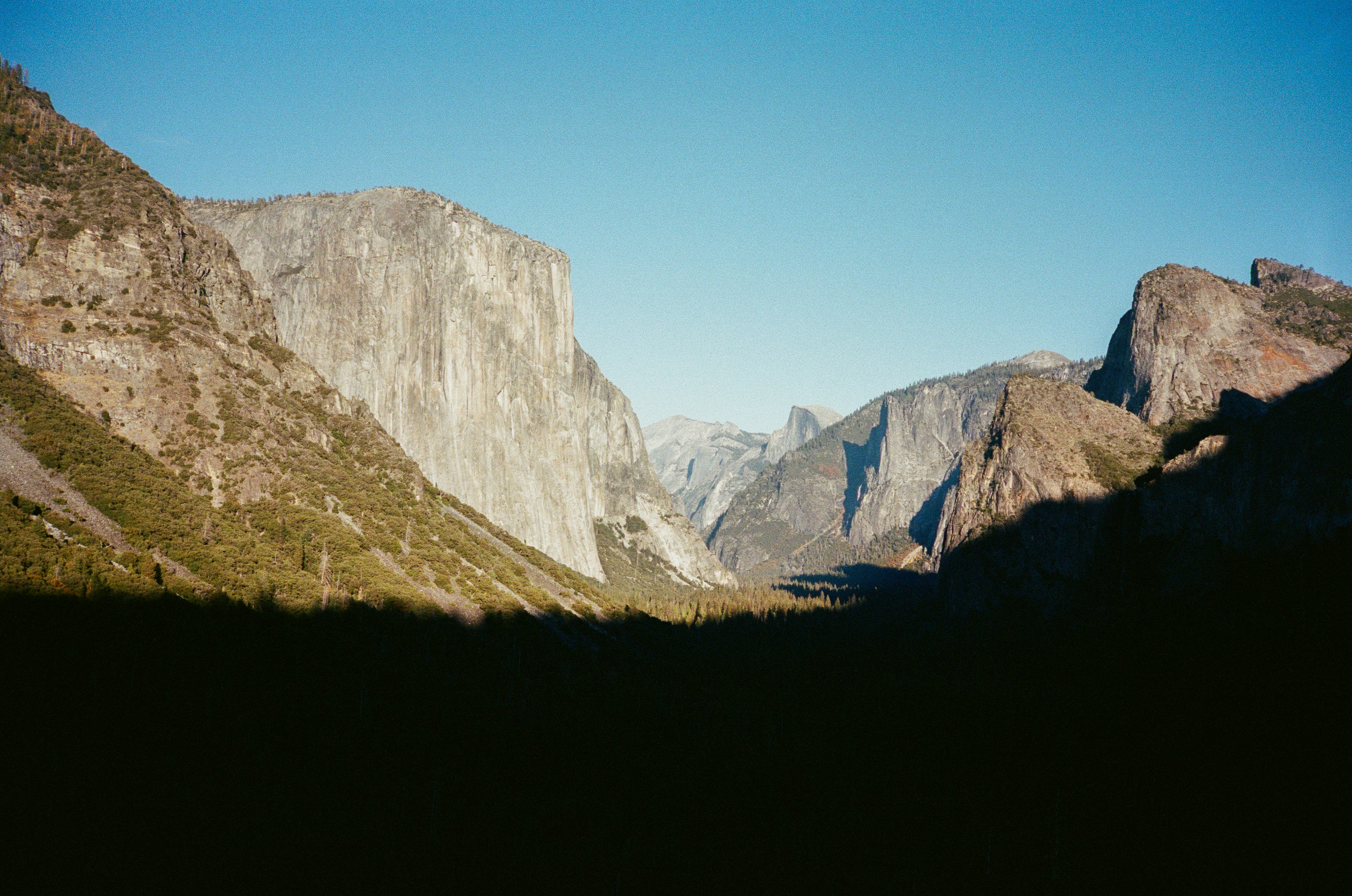 Majestic granite cliffs in yosemite valley under clear blue sky