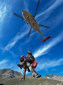 Helicopter rescues person from rocky terrain
