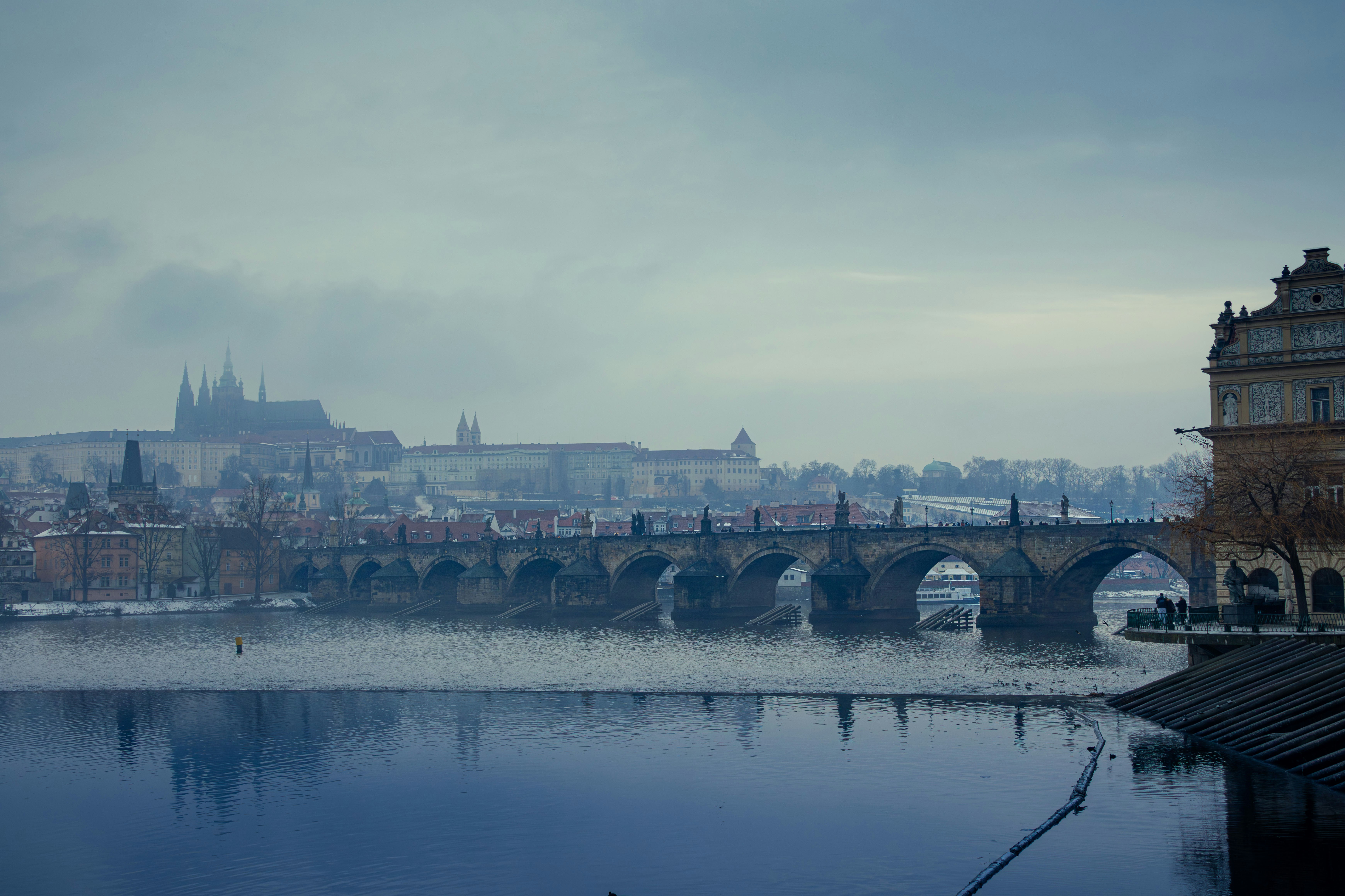 Charles bridge over vltava river in prague with prague castle.