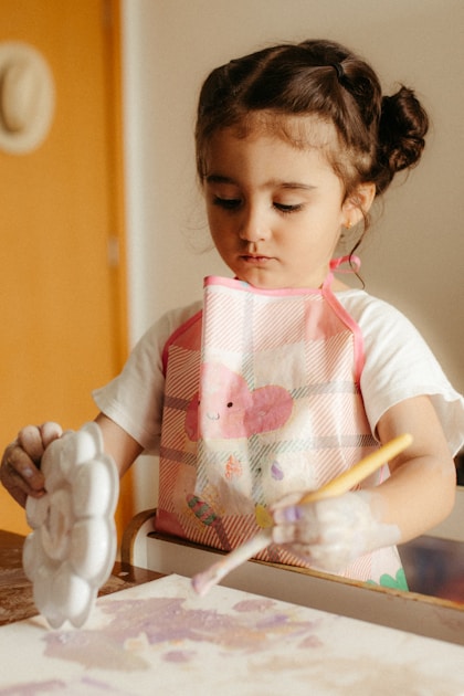 Child painting at table - visual schedules autism creative routines Sydney