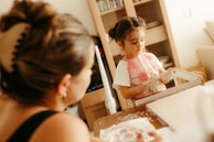 Mother and daughter playing with clay indoors