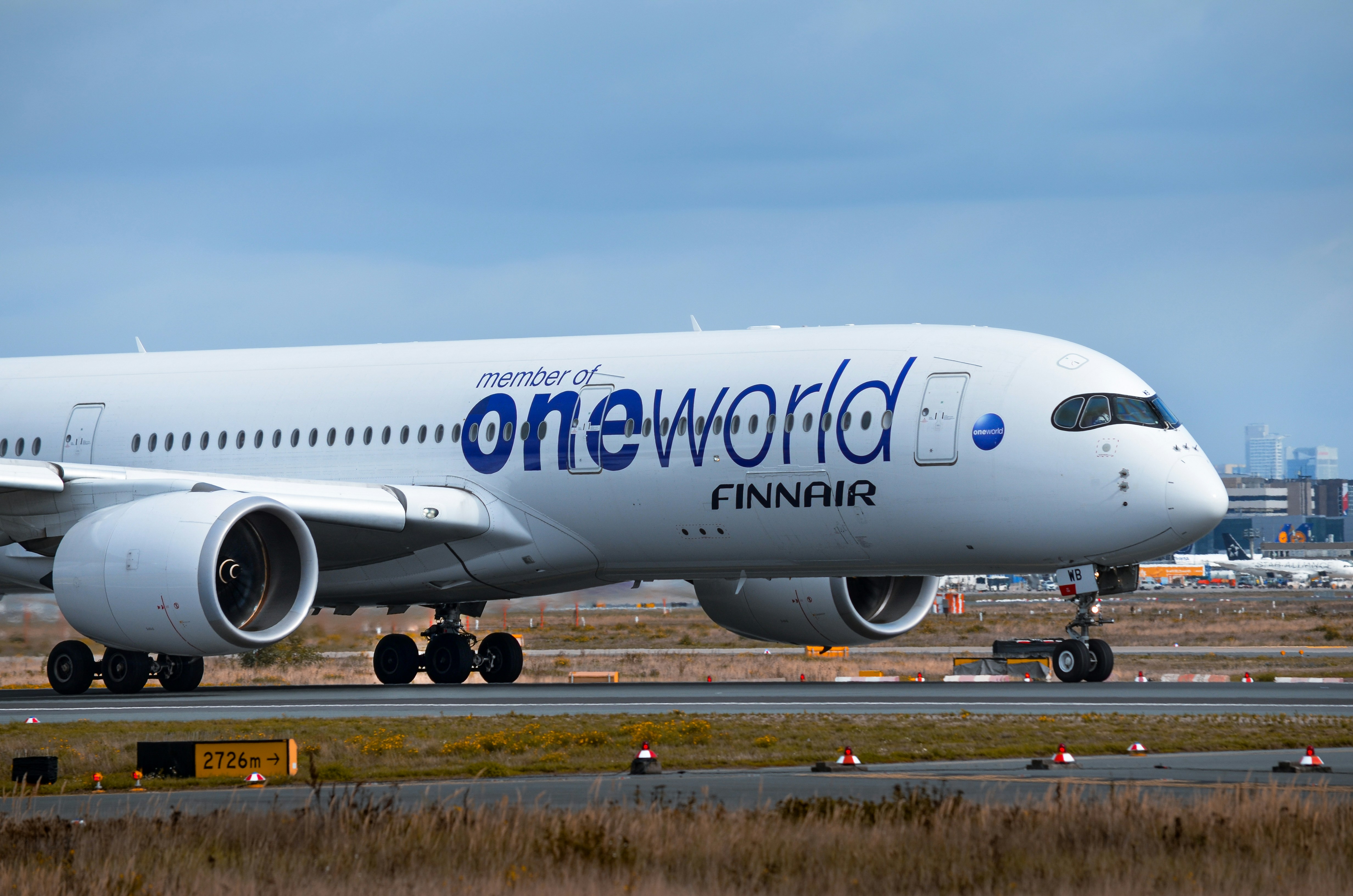 Finnair airplane with oneworld logo on tarmac