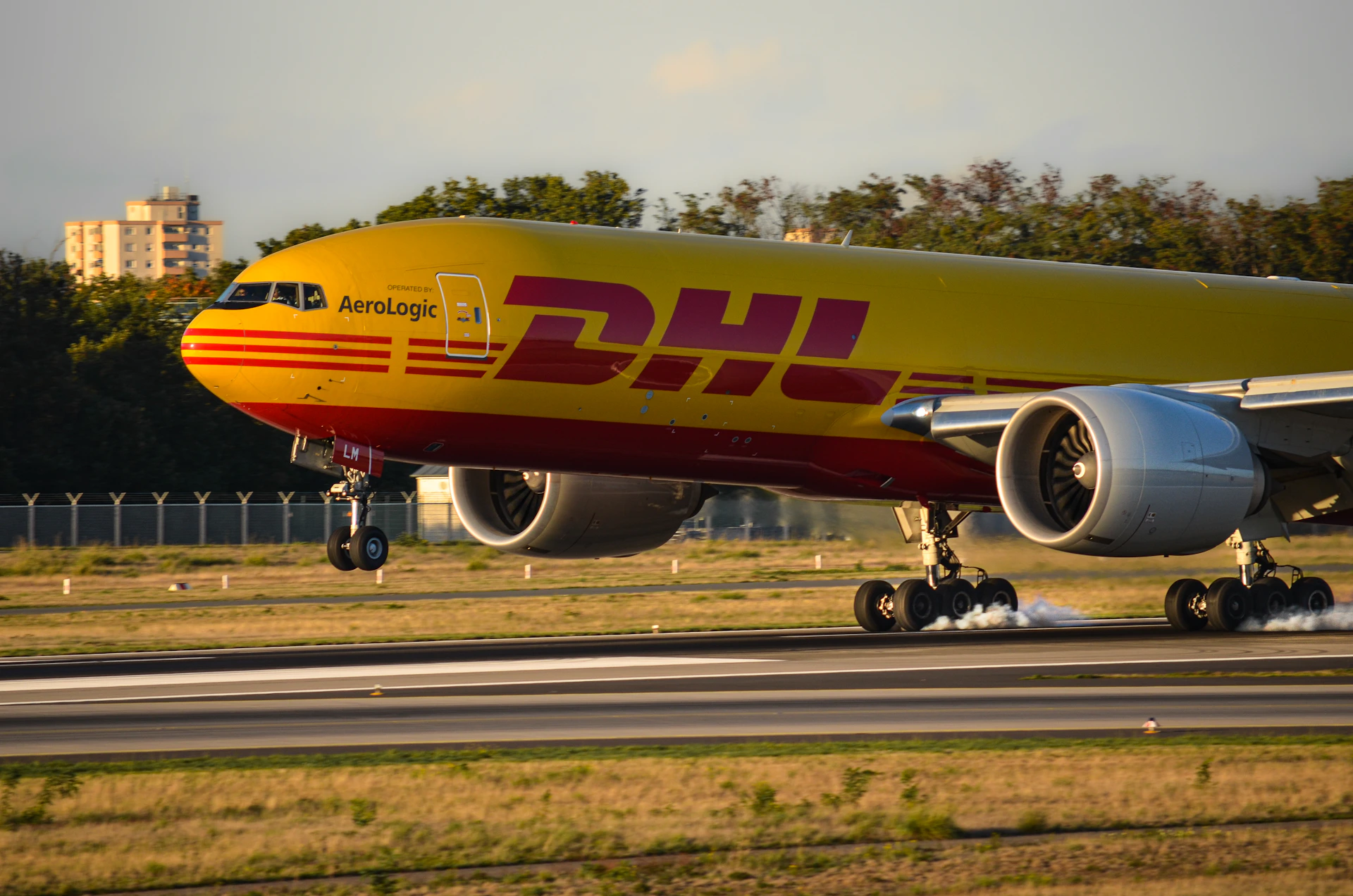 Dhl cargo plane landing on a runway