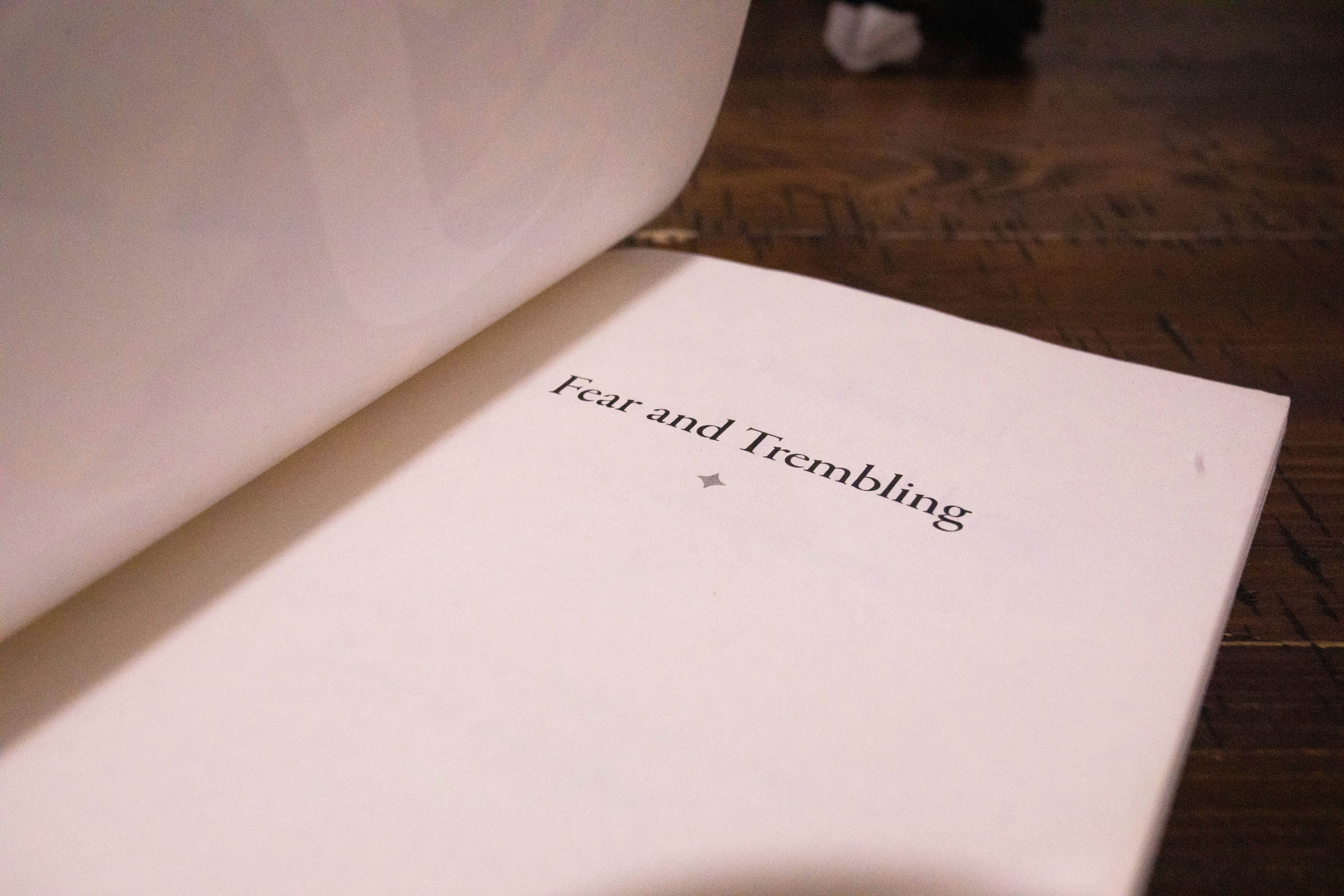 A book open to the title "fear and trembling"