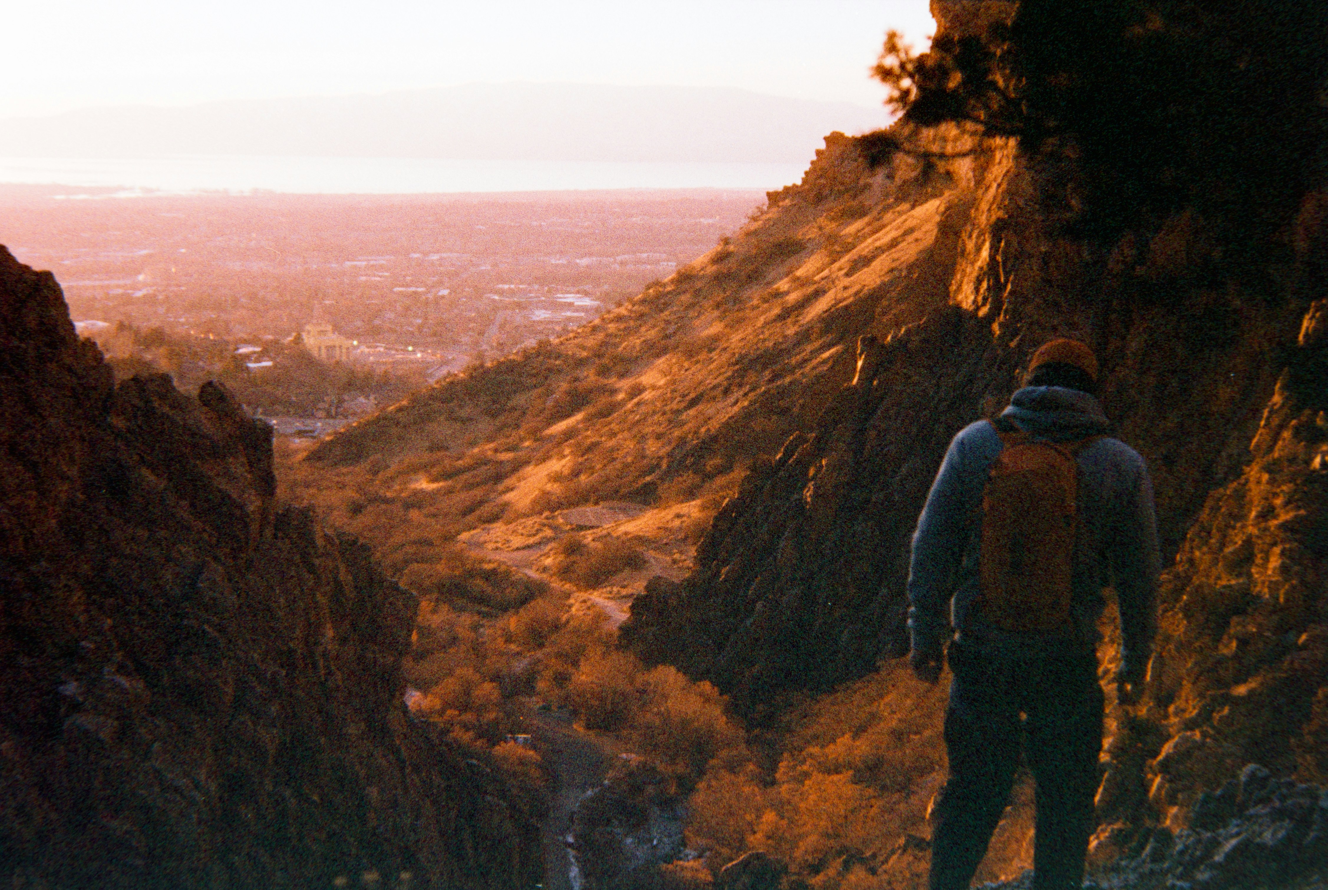 Hiker overlooking a valley at sunset
