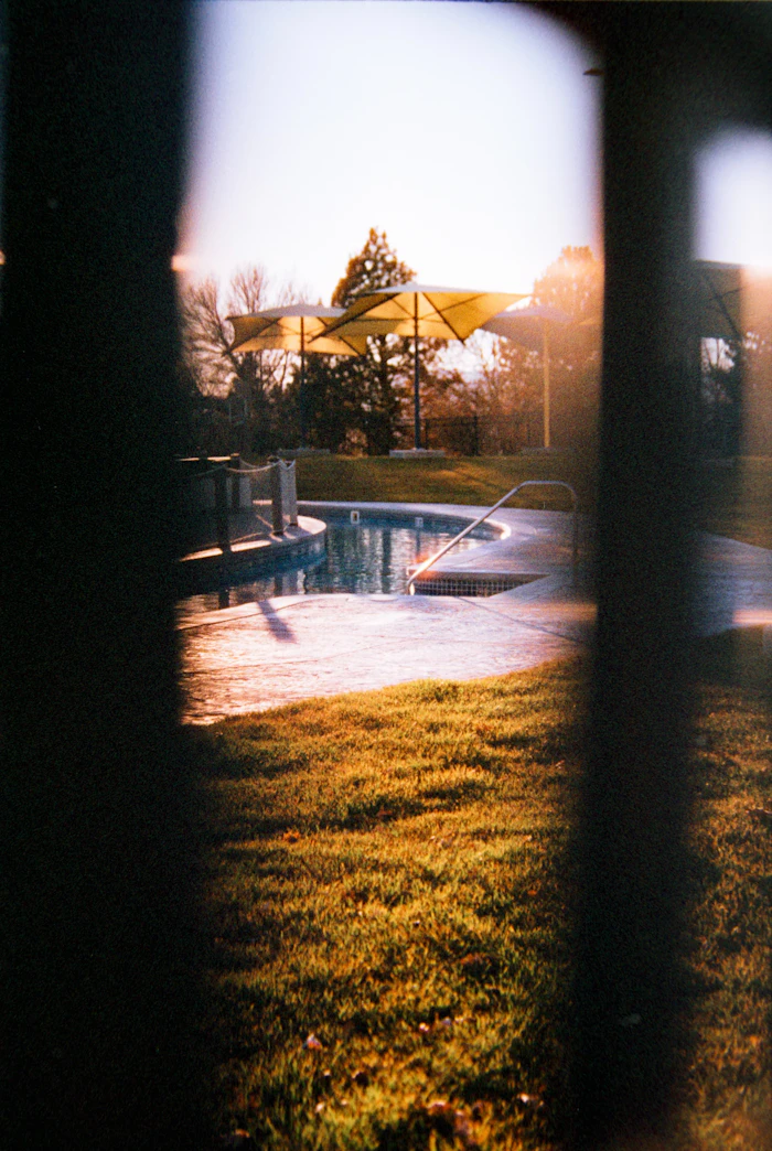 Pool and patio under sunset umbrellas