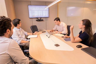 Business meeting with people around a conference table.