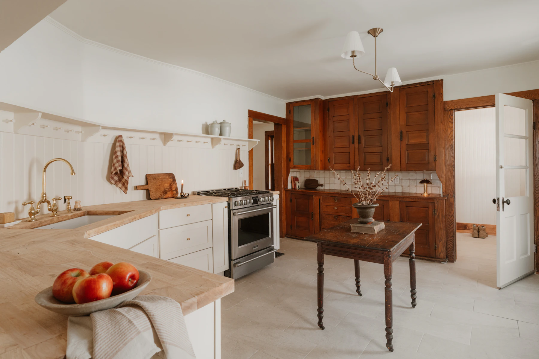 Rustic farmhouse kitchen combining wooden cabinets, modern appliances and a simple cooking area