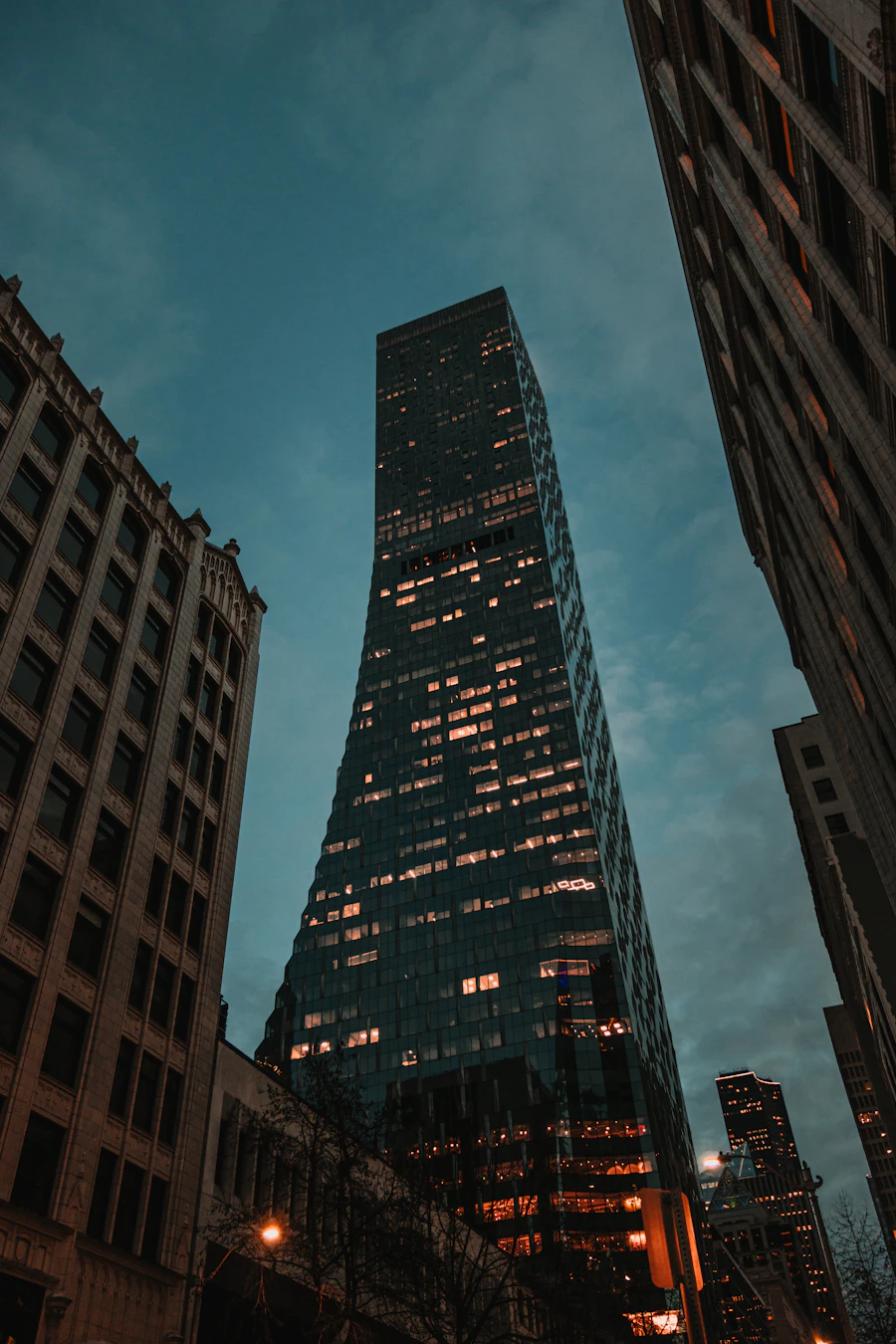 Modern glass skyscraper at dusk — corporate finance environment