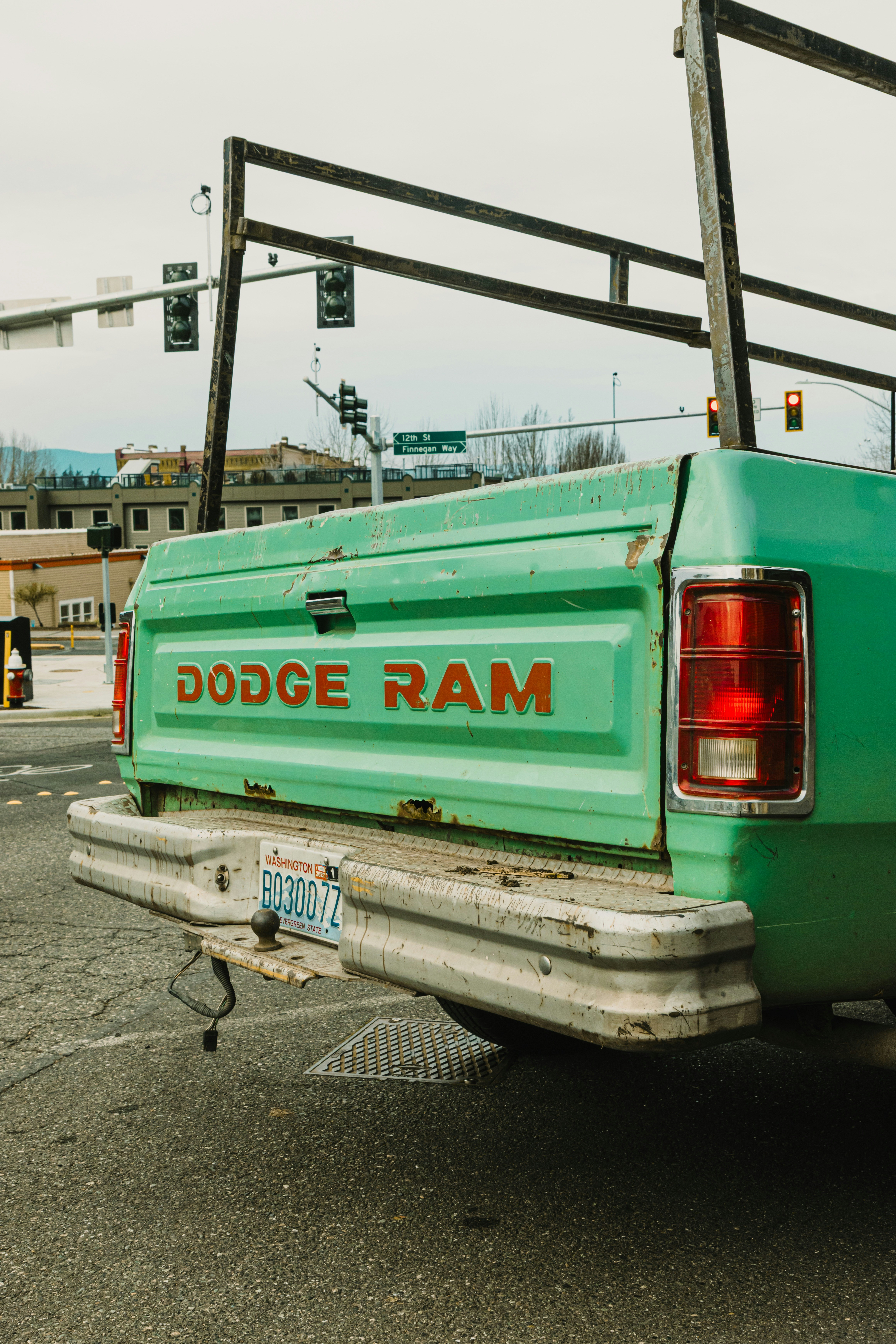 Green dodge ram truck at an intersection