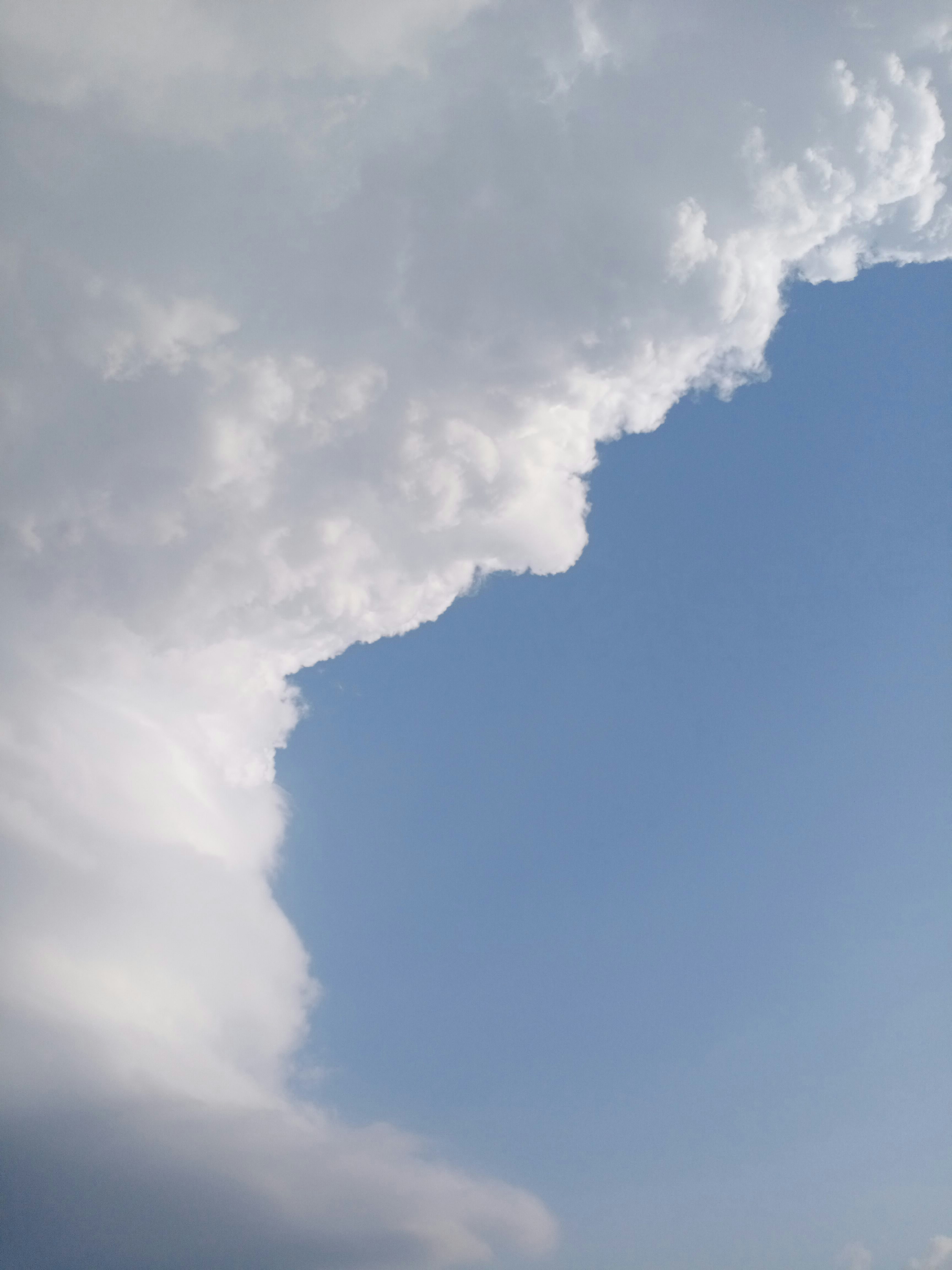 Fluffy white clouds against a clear blue sky