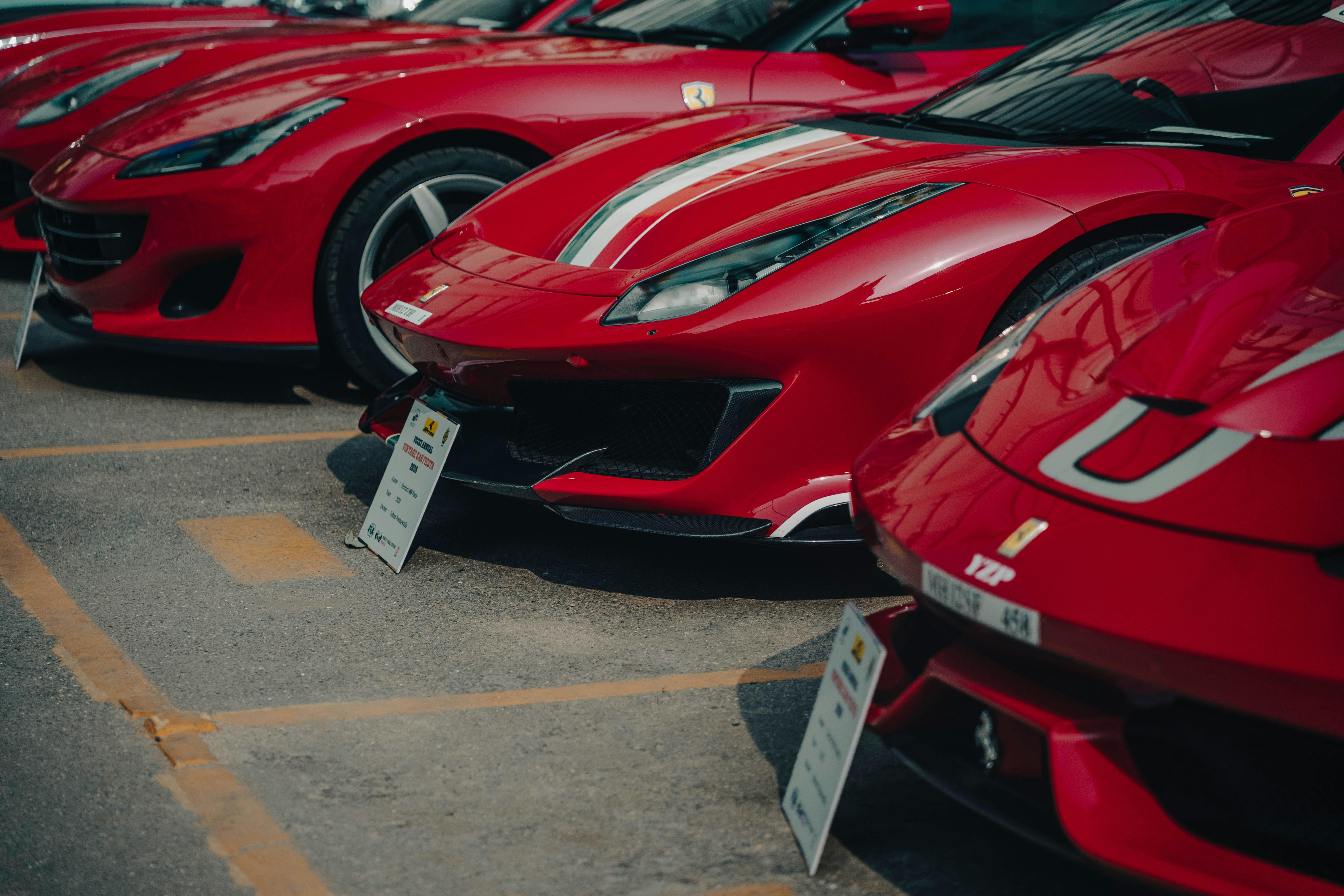 Several red sports cars parked in a row.