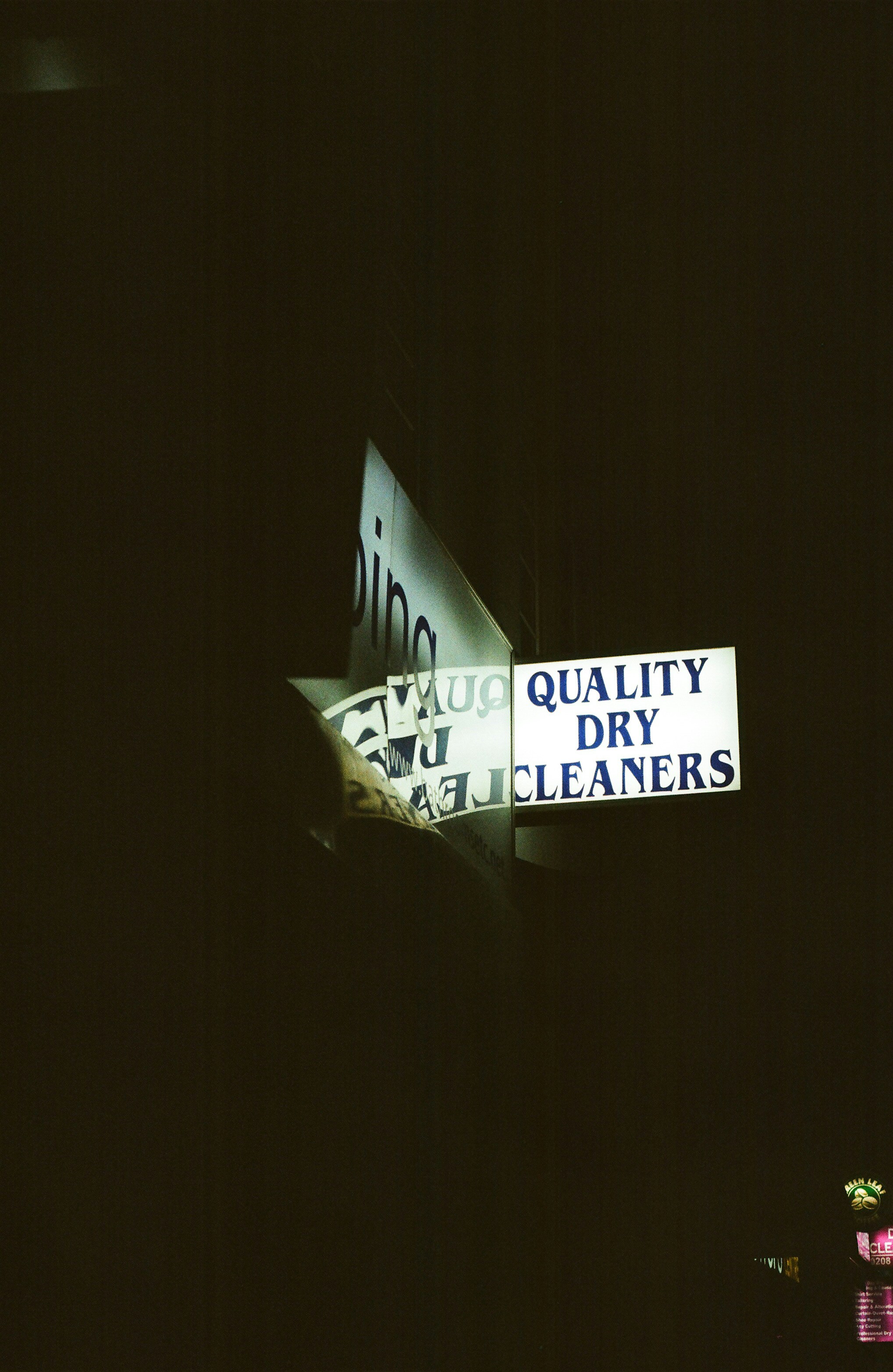 Quality dry cleaners sign at night