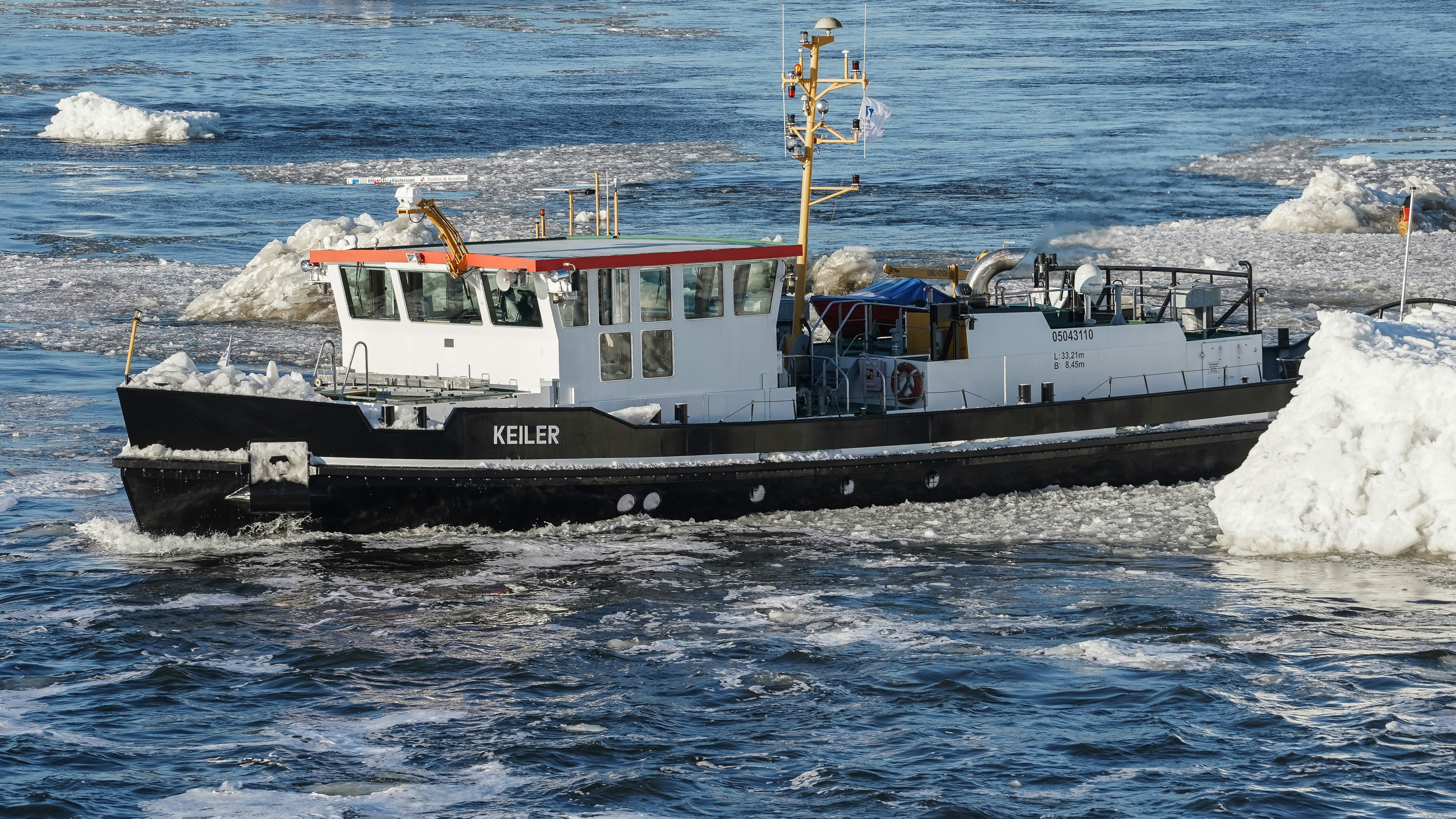 A boat navigates through icy waters