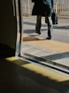 Man with briefcase walks onto a train platform.