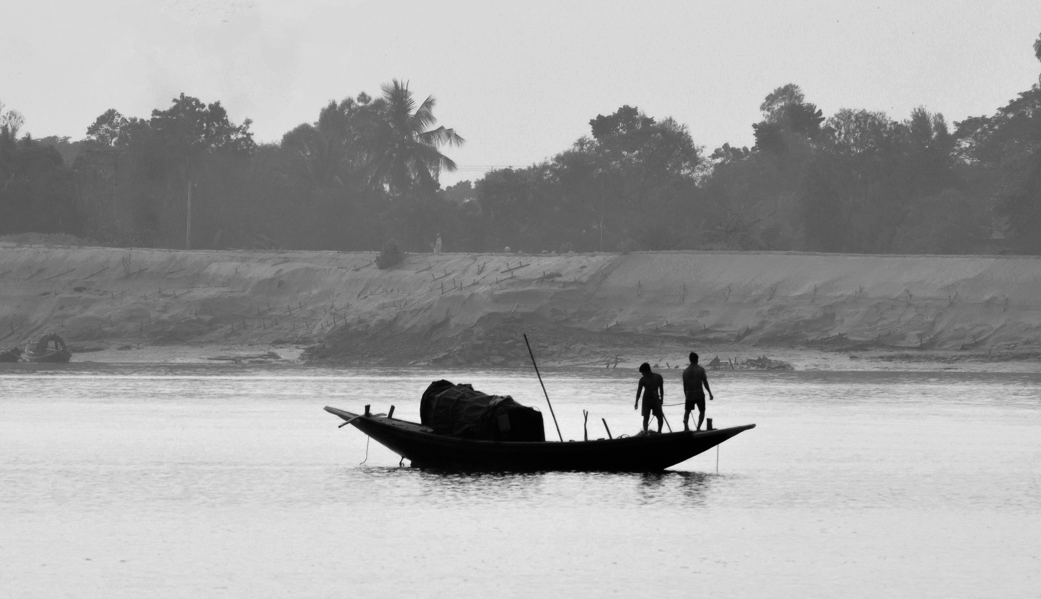 Two people on a boat on the water