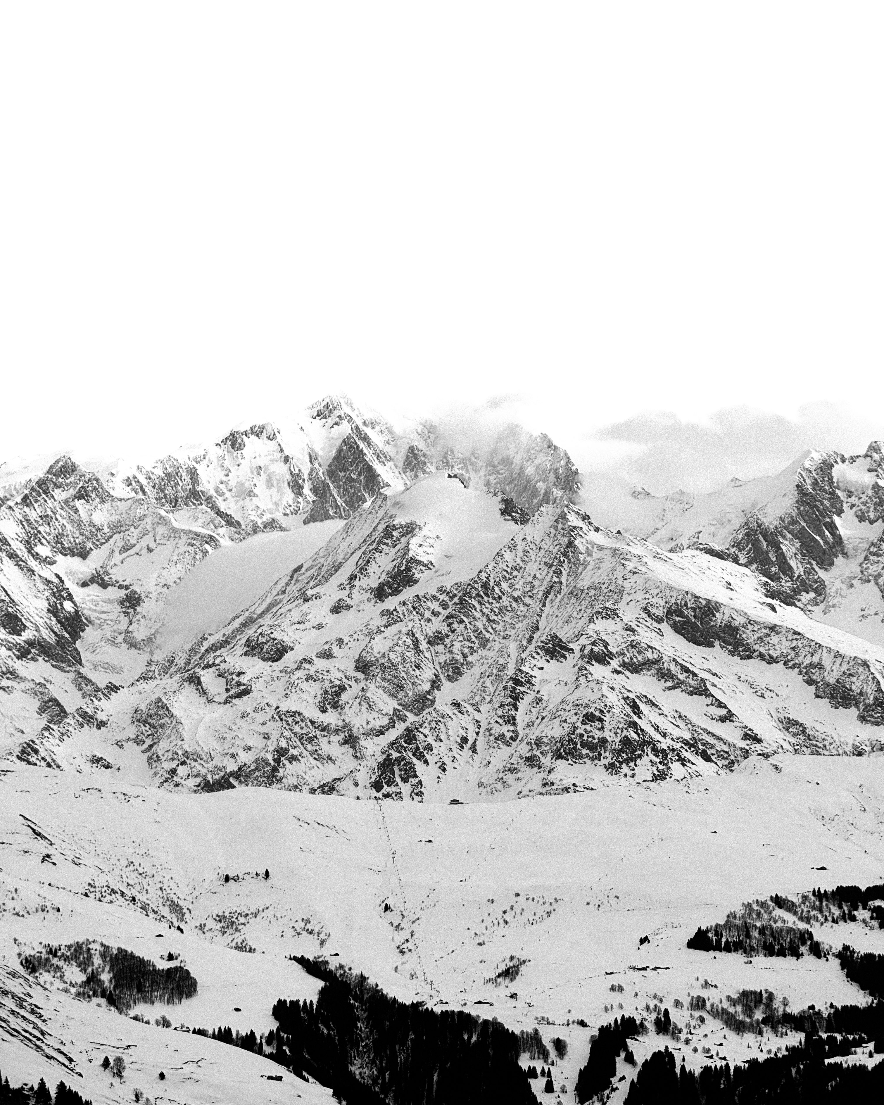 Snow-covered mountain range under a bright sky