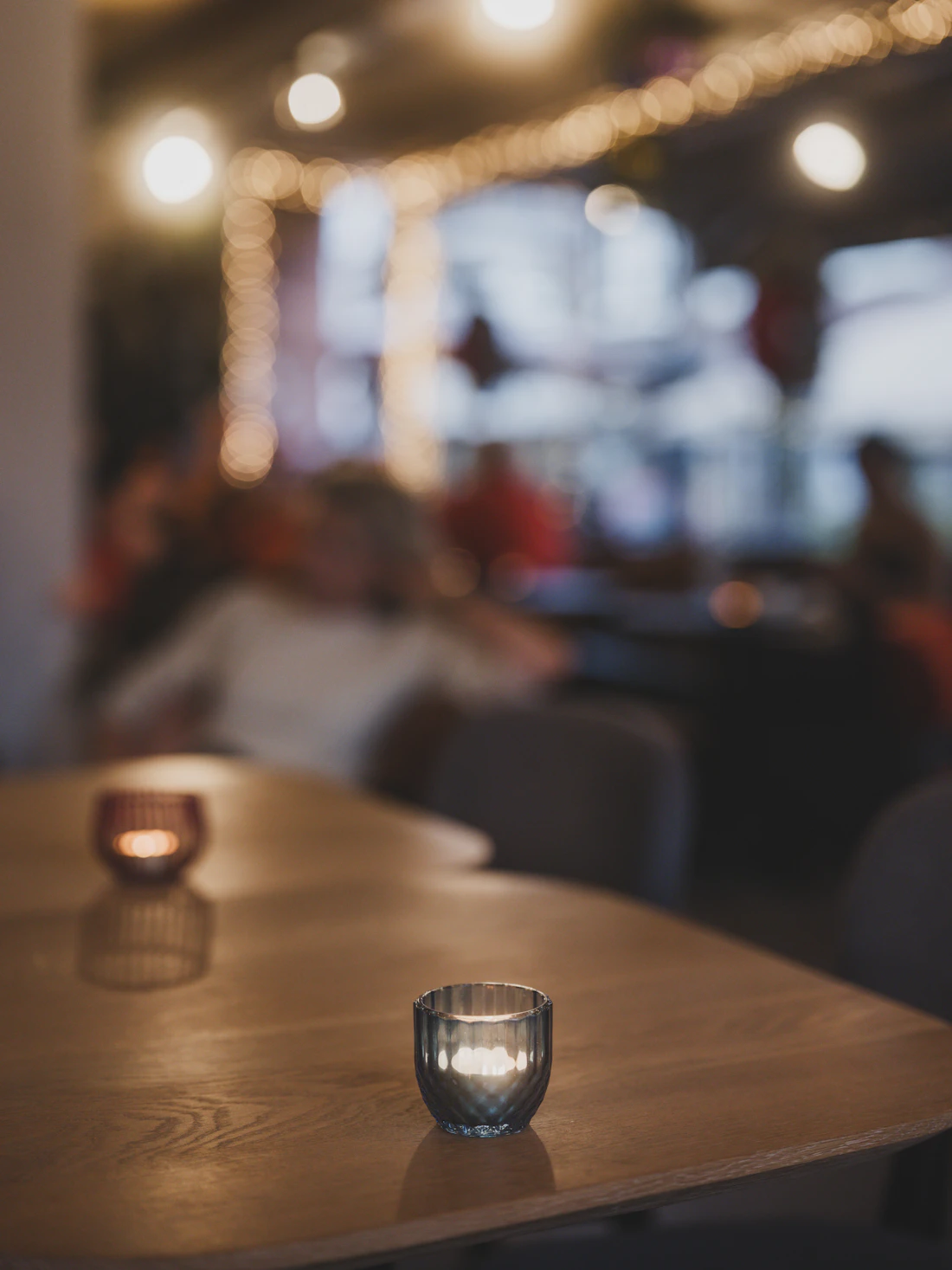Two candle holders on a wooden table