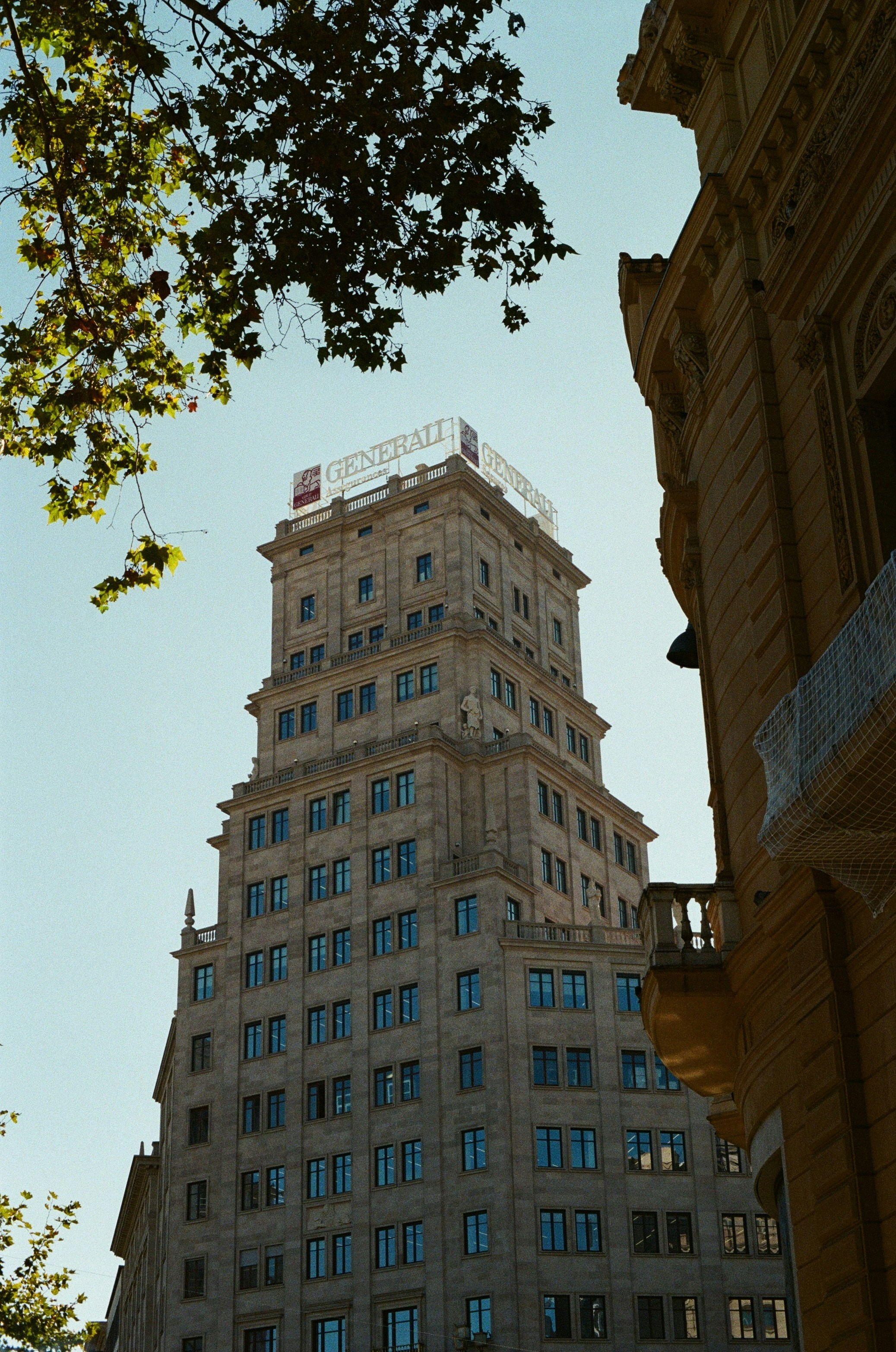 Tall historic building with generali sign on top