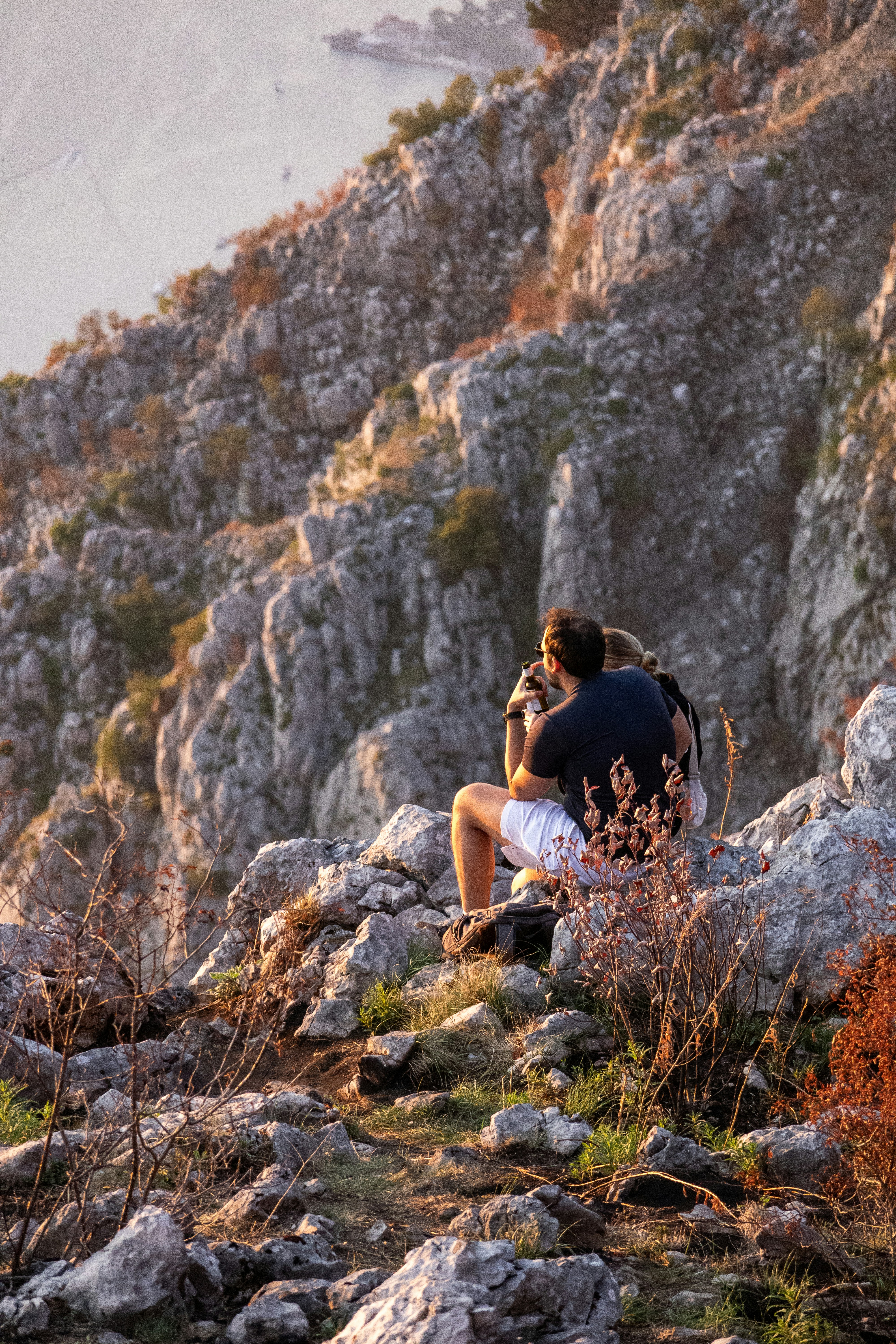 Hombre fotografiando desde un mirador de las montañas rocosas.