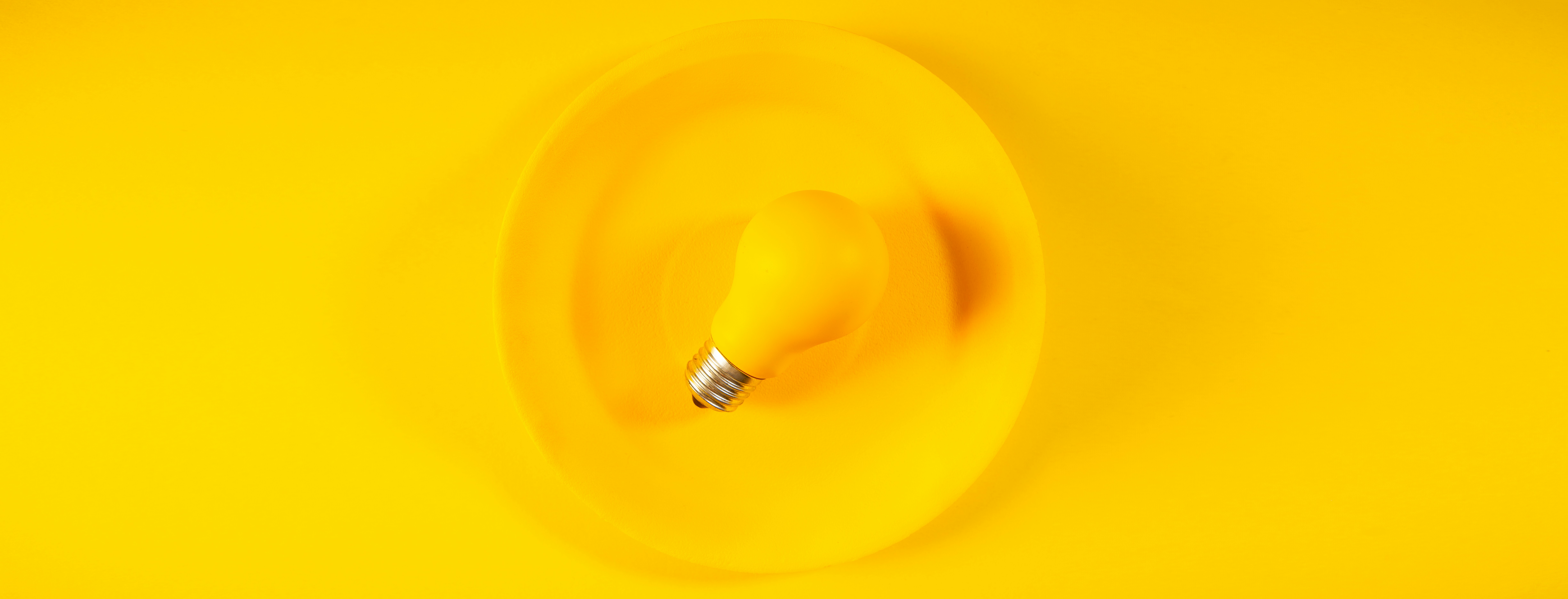 A light bulb spinning on a yellow background