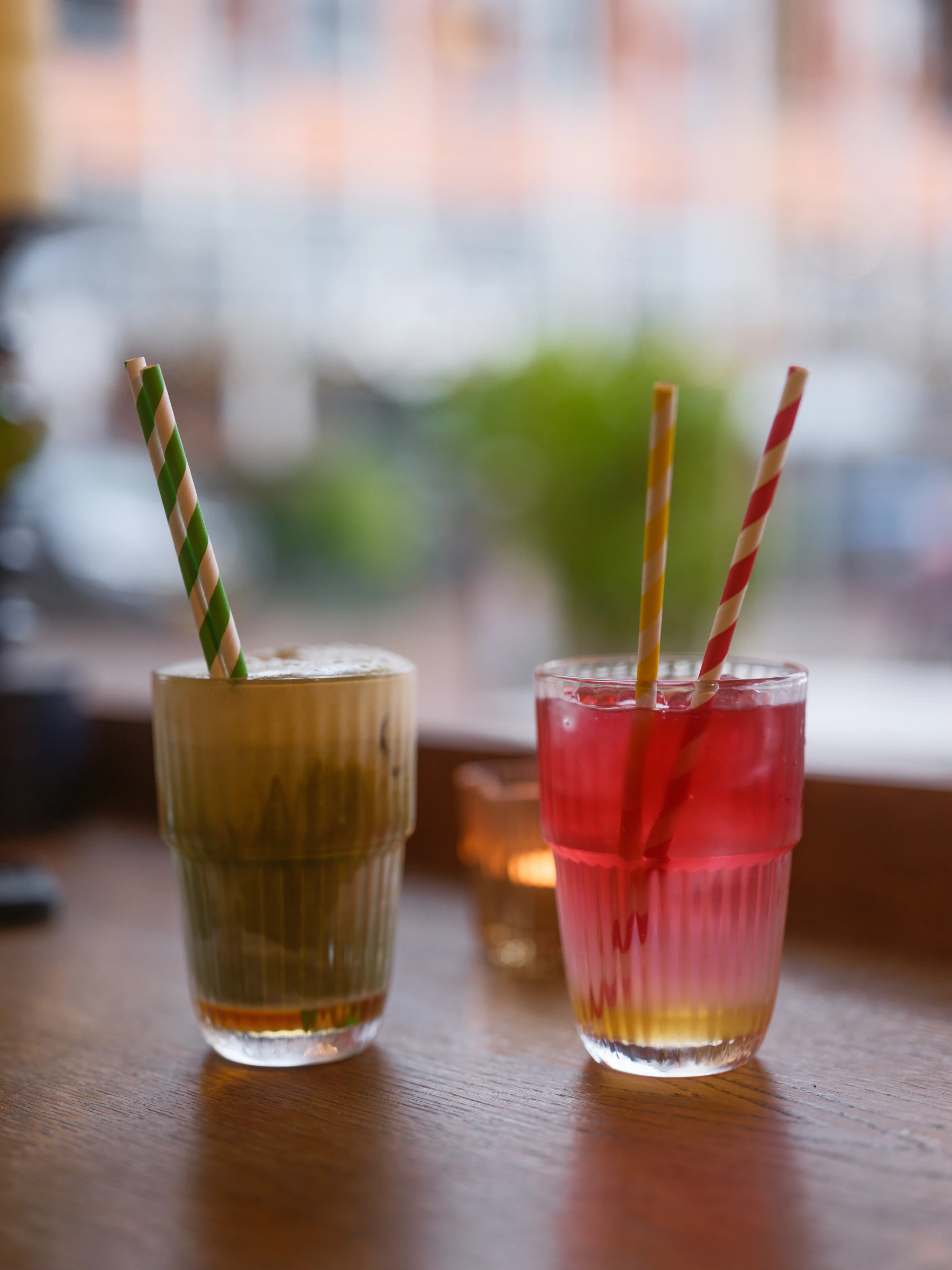 Two chilled drinks served in textured drinking glasses
